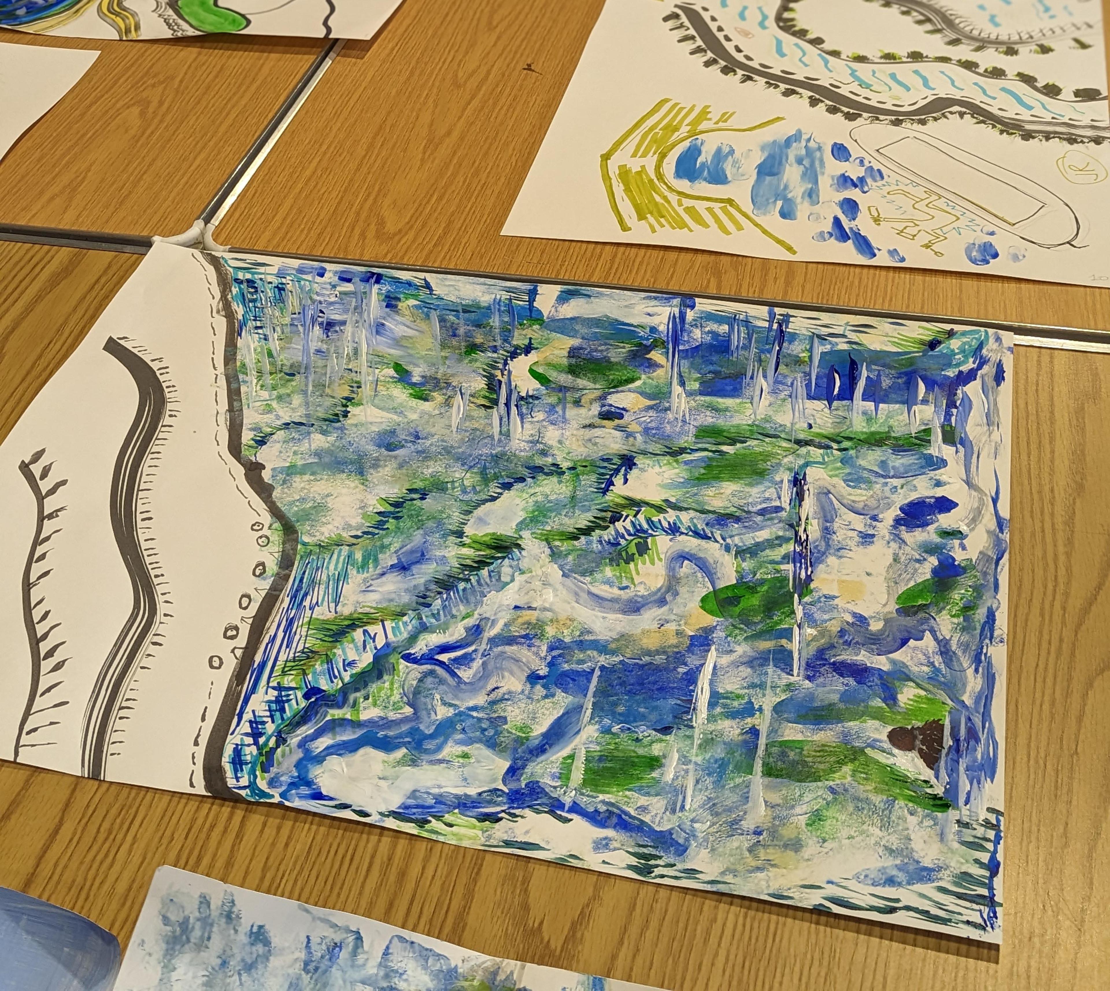 Sheets of illustrated paper on a table.