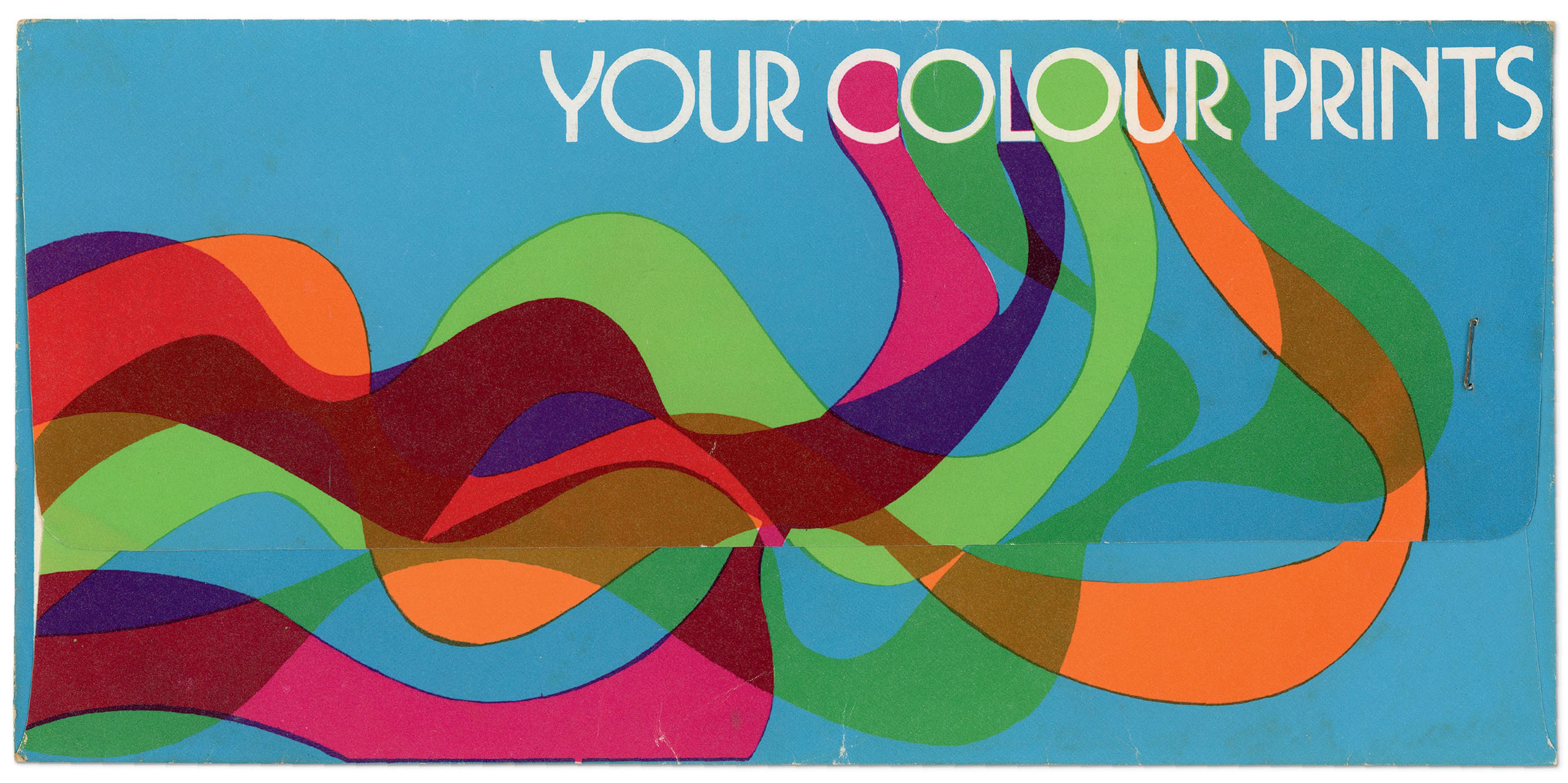 Photo of an envelope with colourful wavy lines with the text 'YOUR COLOUR PRINTS'.
