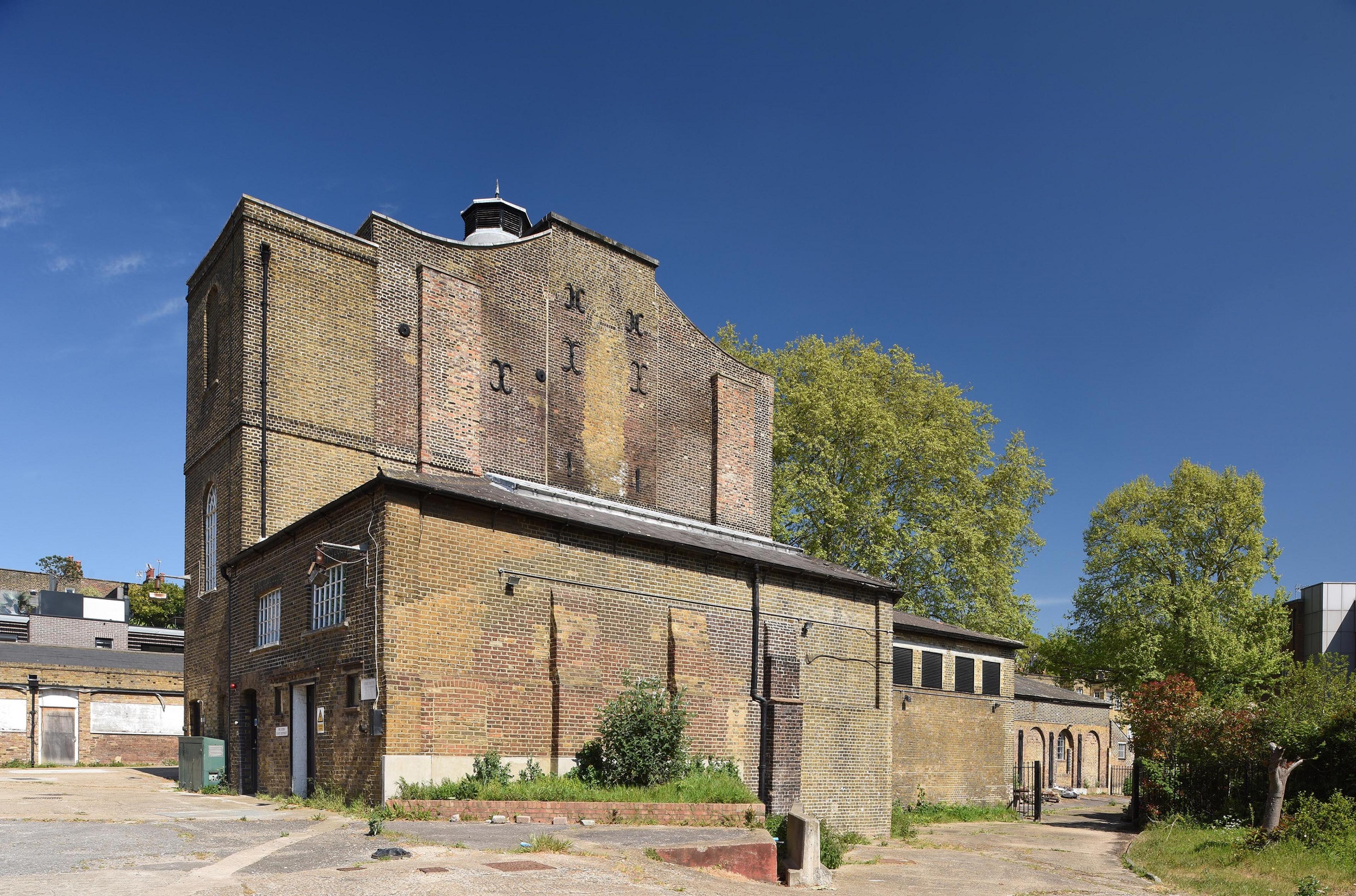 Industrial brick building with blue sky above