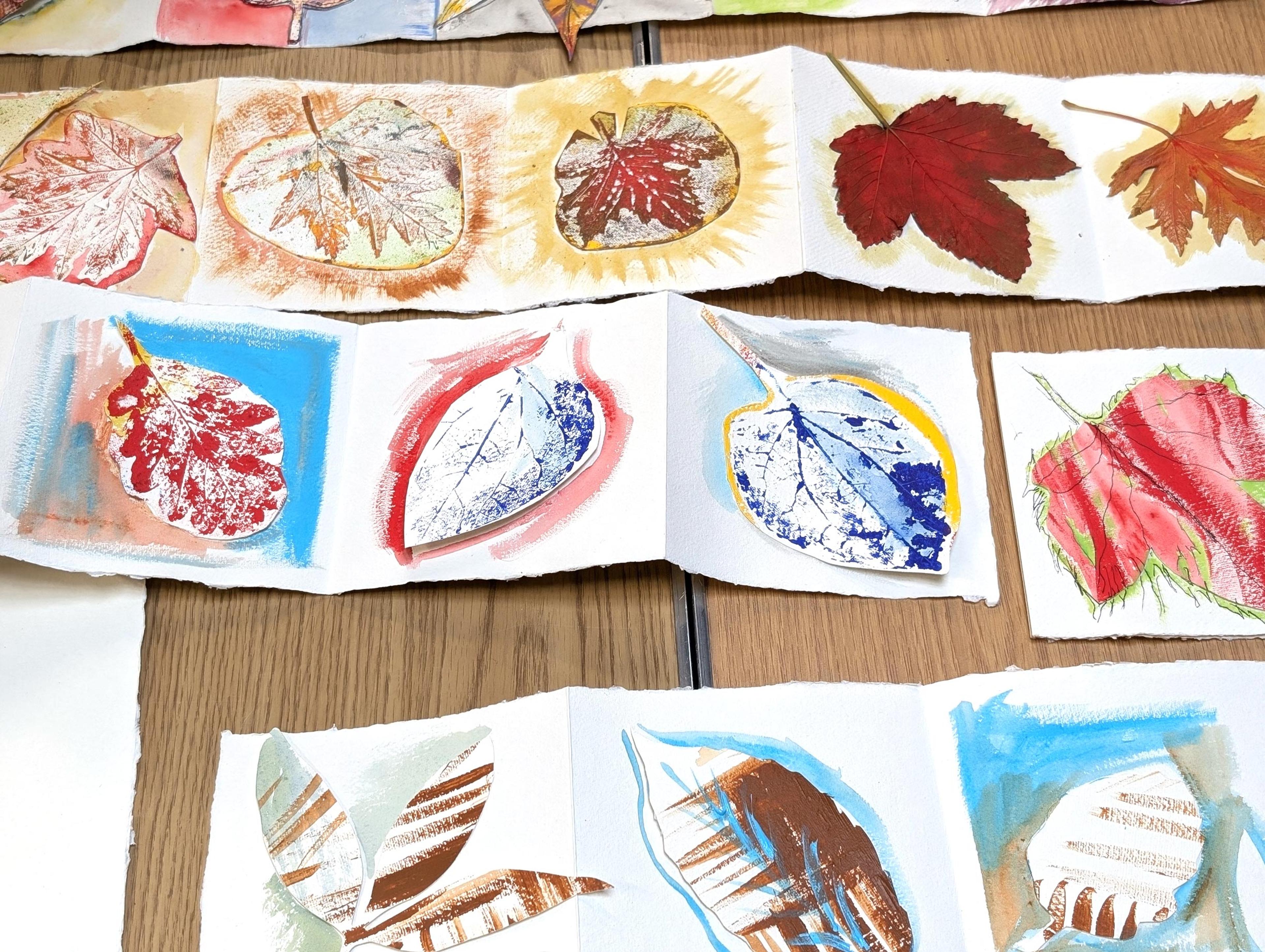 A table covered in colourful illustrations of different leaves.