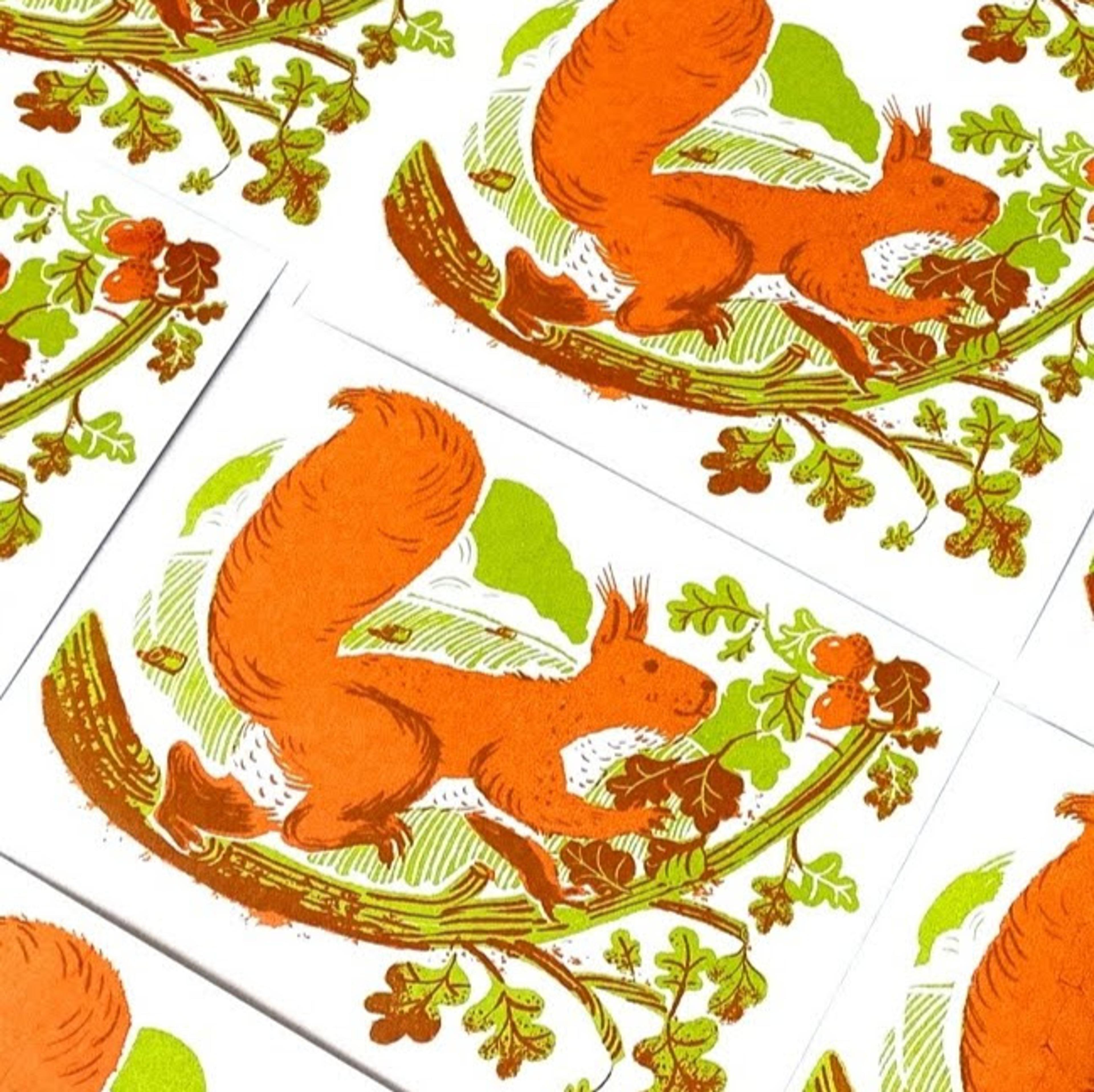 Multiples of lithograph prints all with illustrations of a squirrel on a tree looking at acorns.