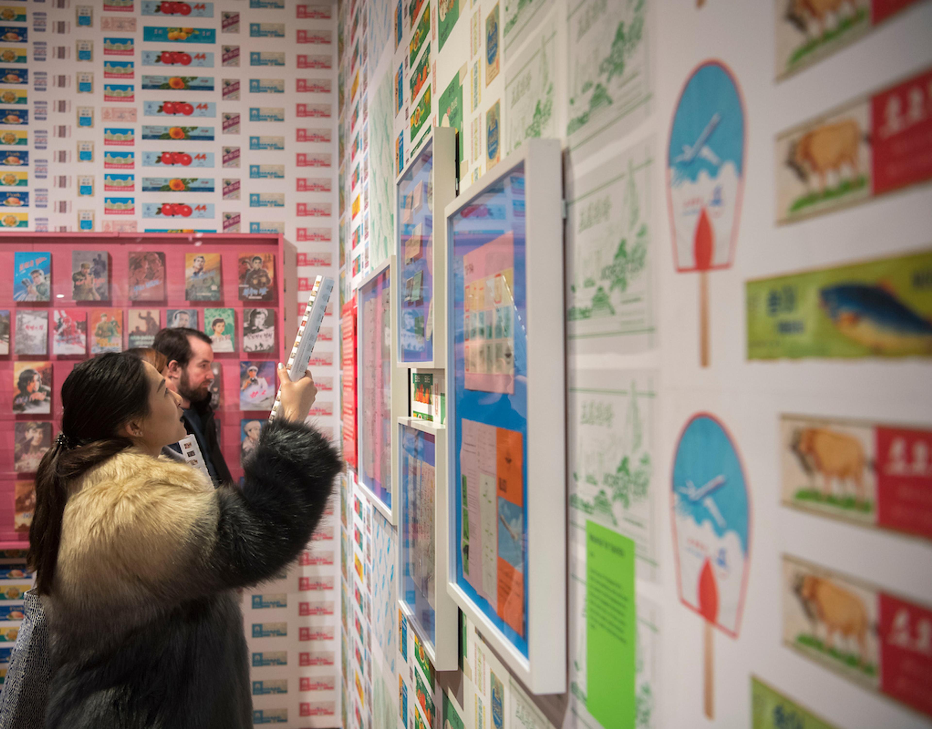 Photograph of two people in an exhibition