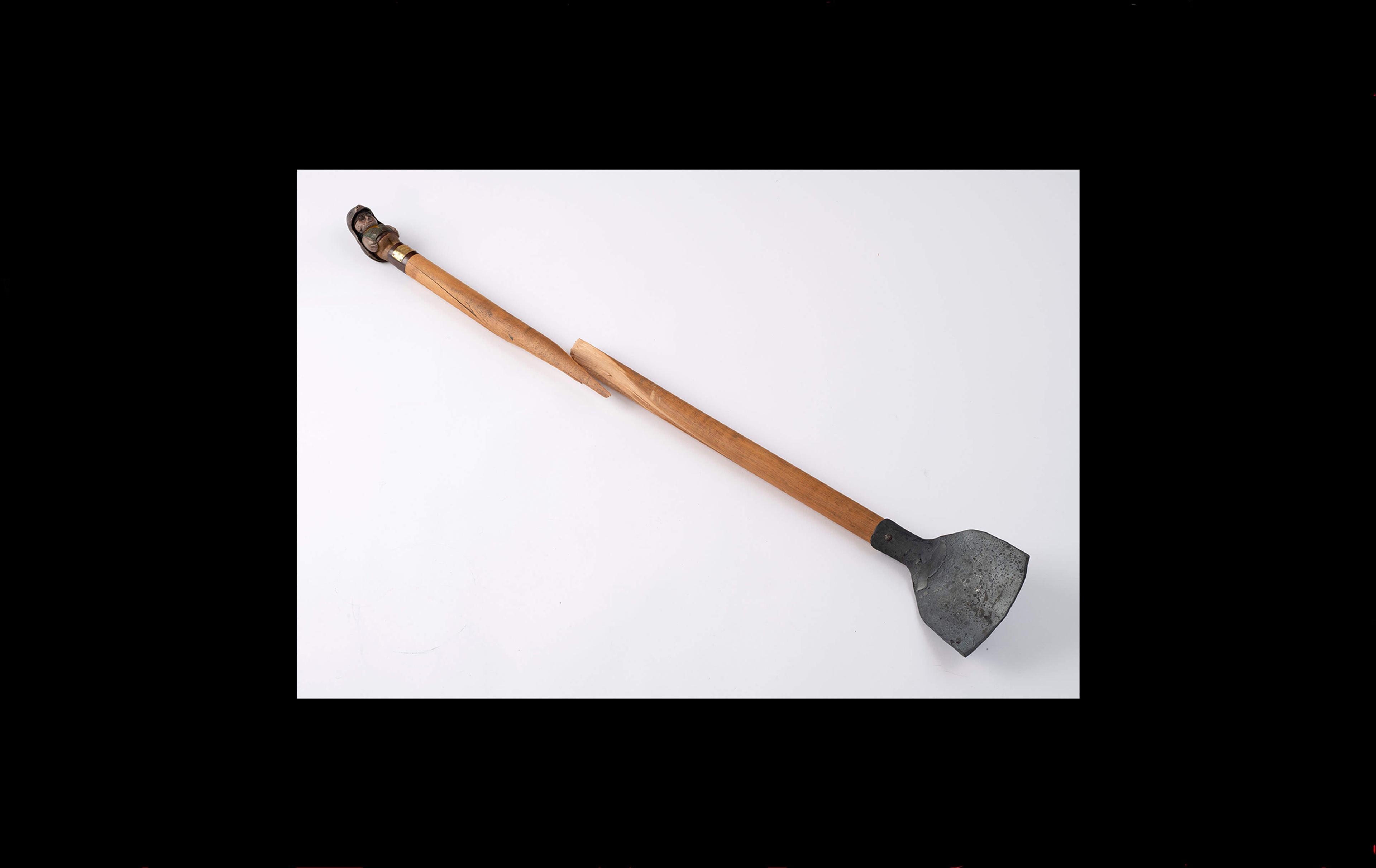 Photograph of a long spade, broken in the centre