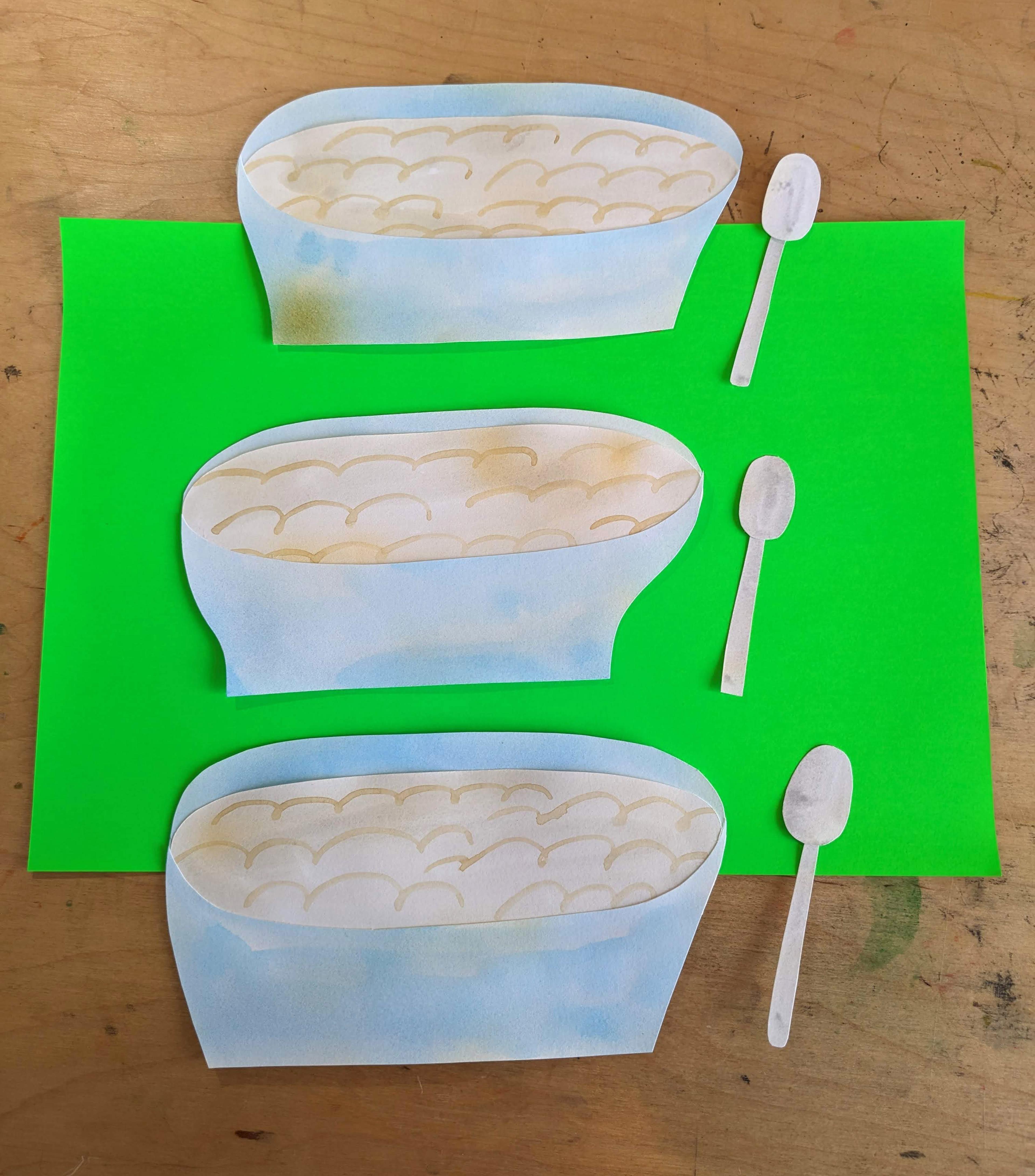 Illustrations of three bowls of porridge with spoons on a green piece of paper on top of a table.