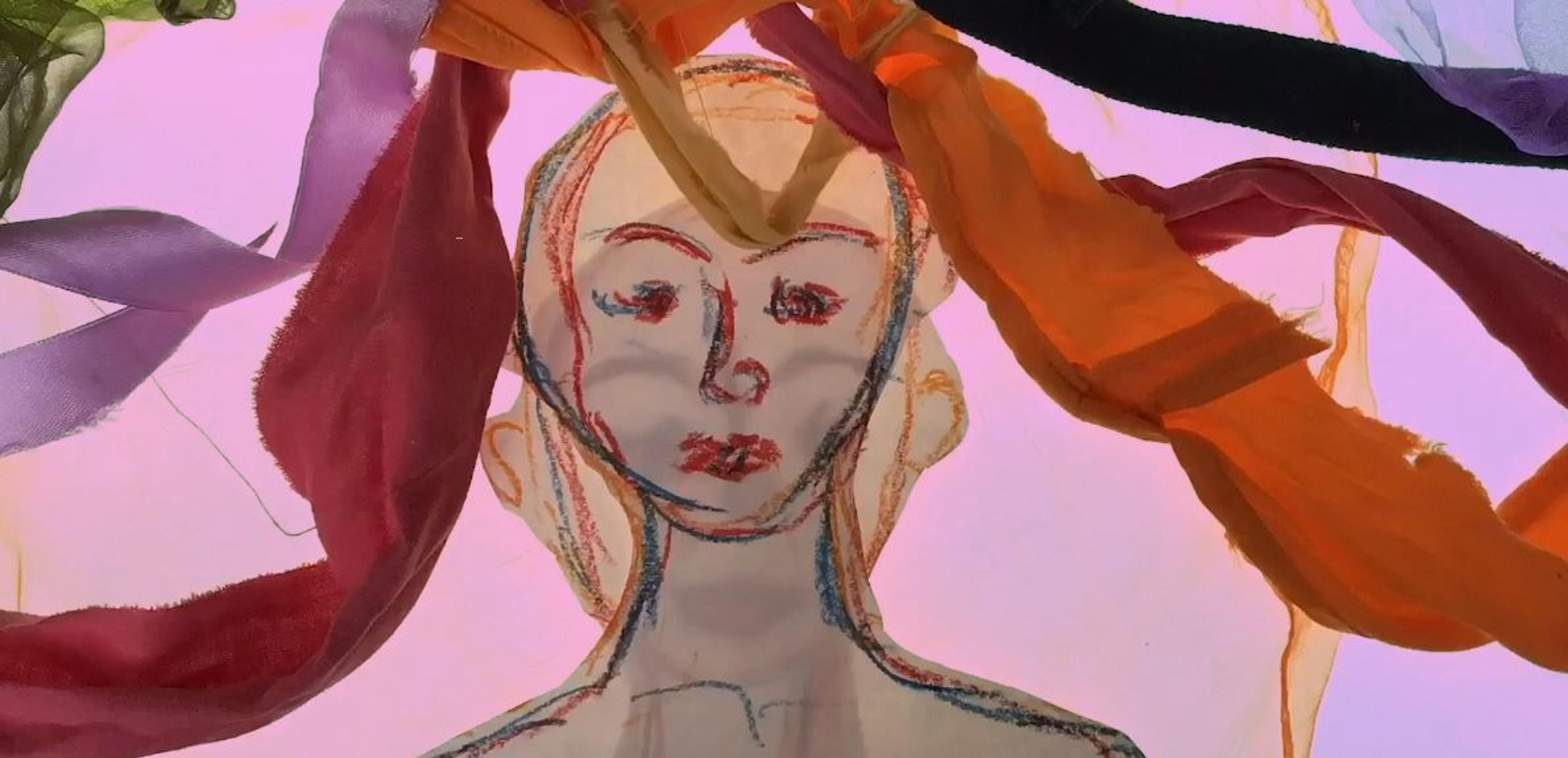 A still from an animation with a two pencil drawn people in the centre layered on top of one another. Strips of colourful fabric lay on top of the drawings, like hair.