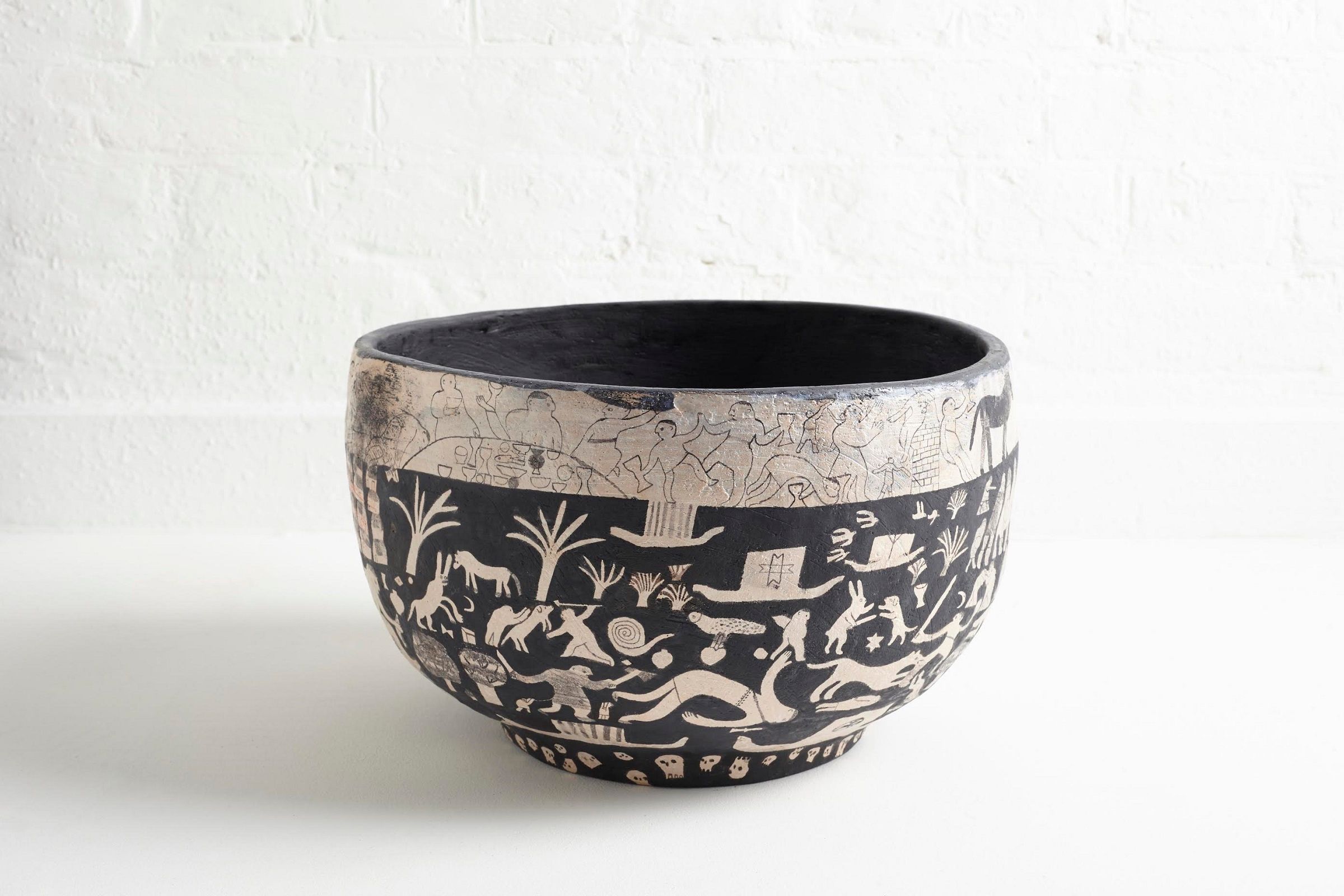 Photograph of a bowl decorated with people and animals