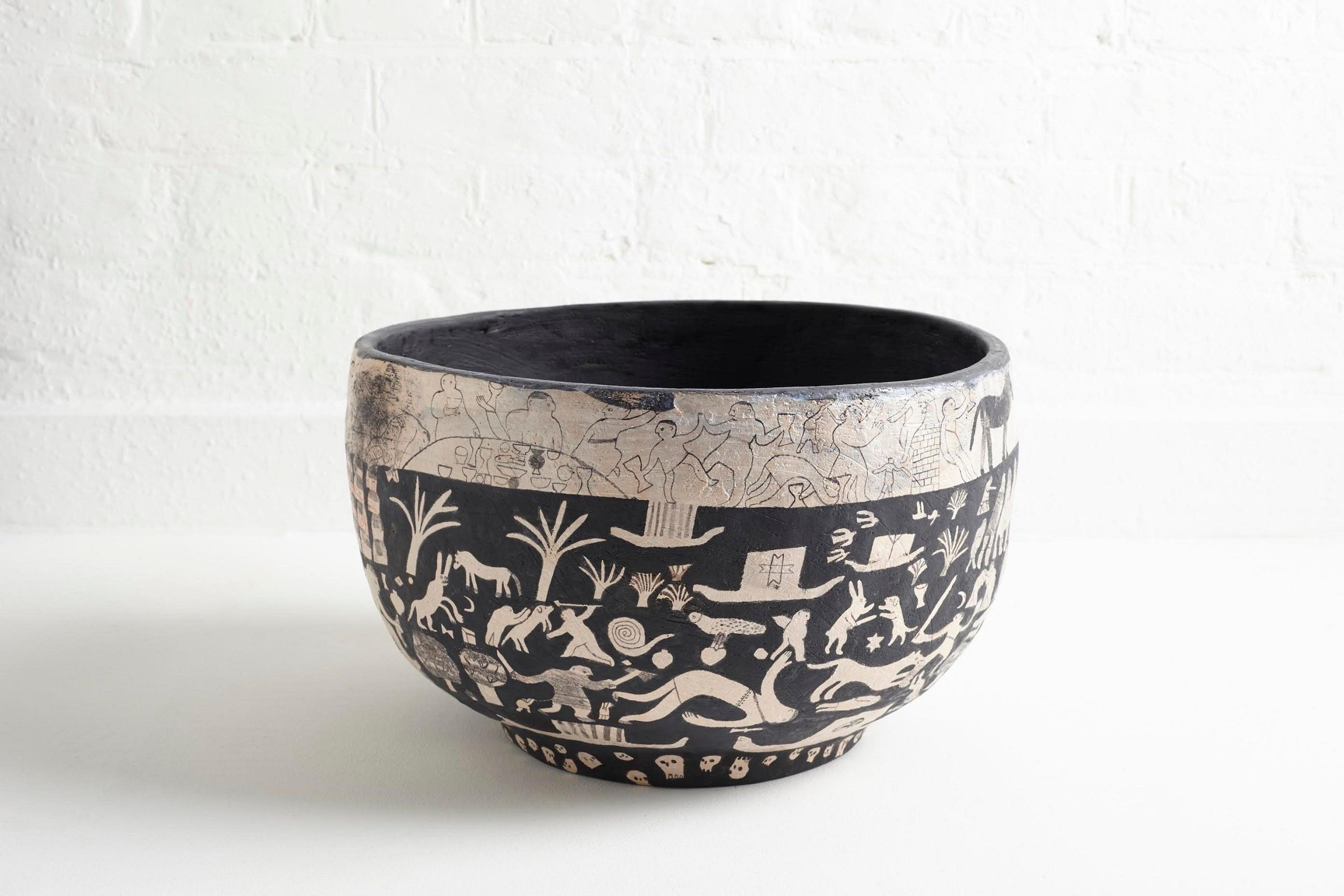 Photograph of a bowl decorated with people and animals