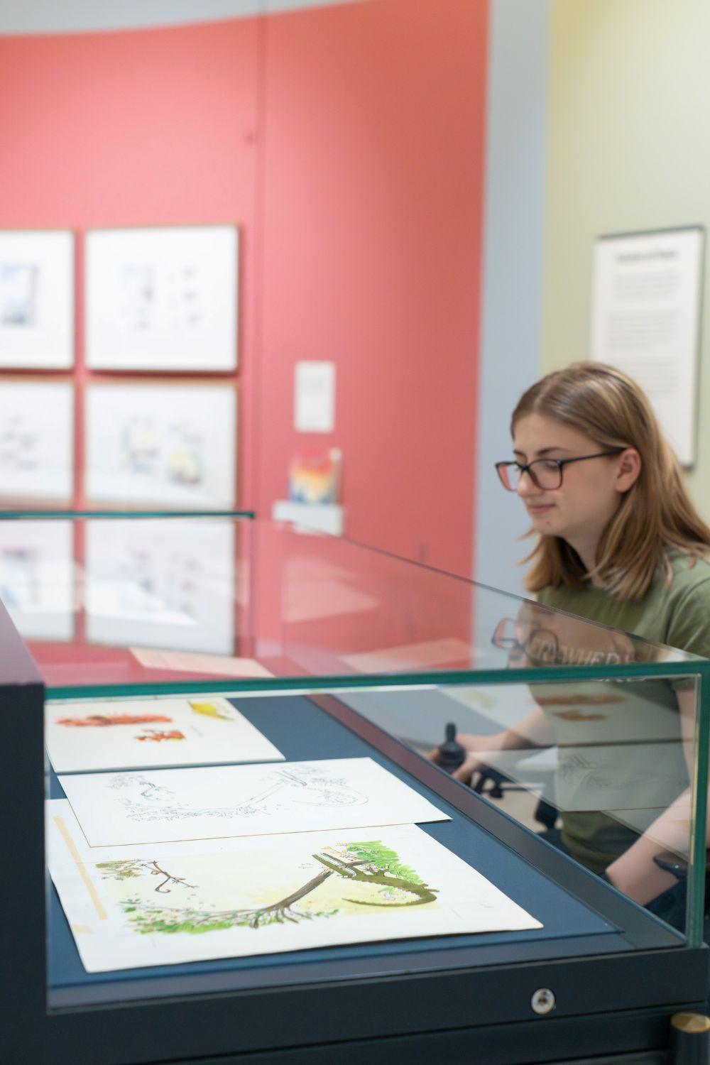 A woman in wheelchair looks at art