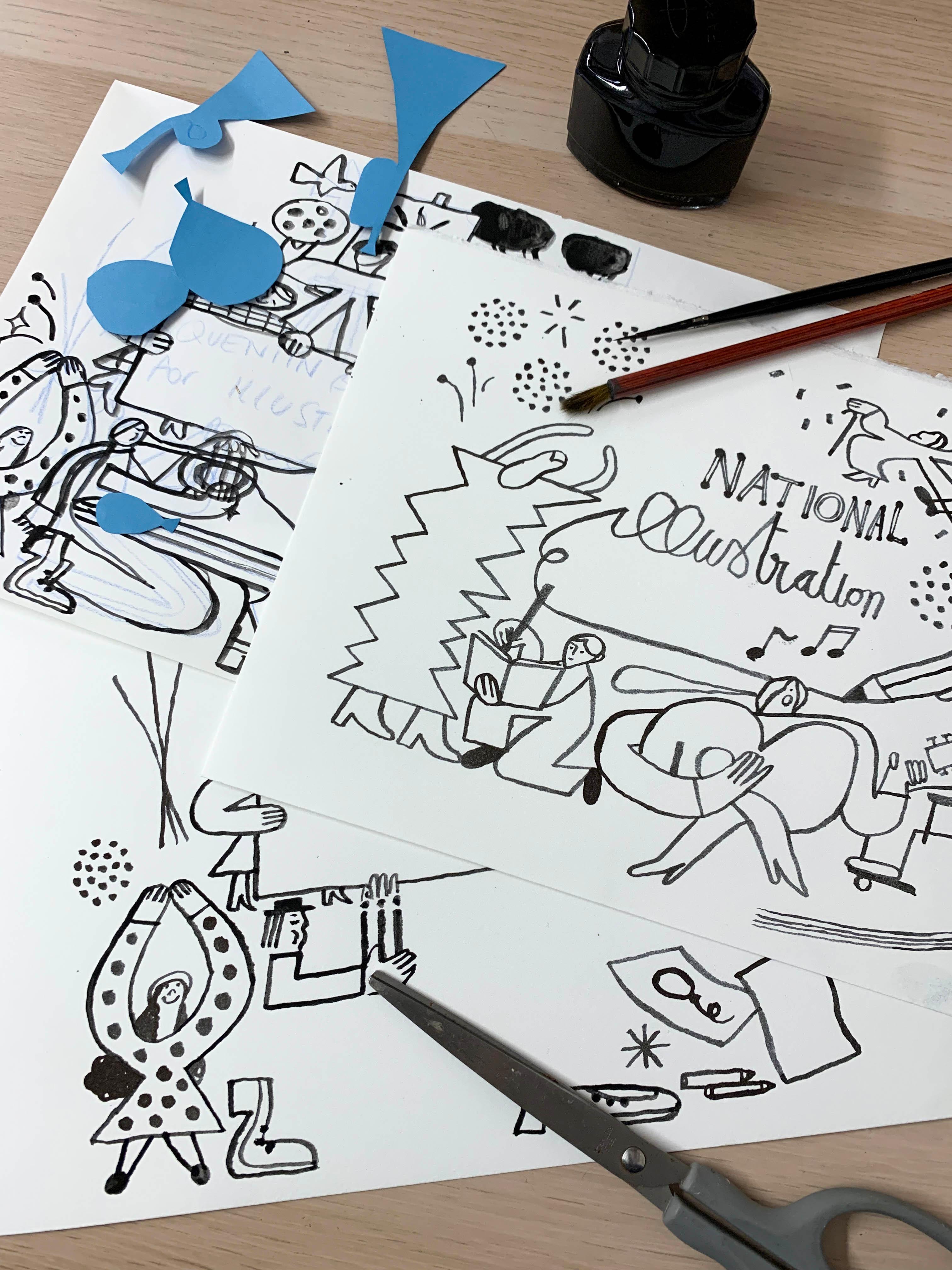 Black and white illustrations on a table surrounded by paint brushes, paper cut outs and scissors.