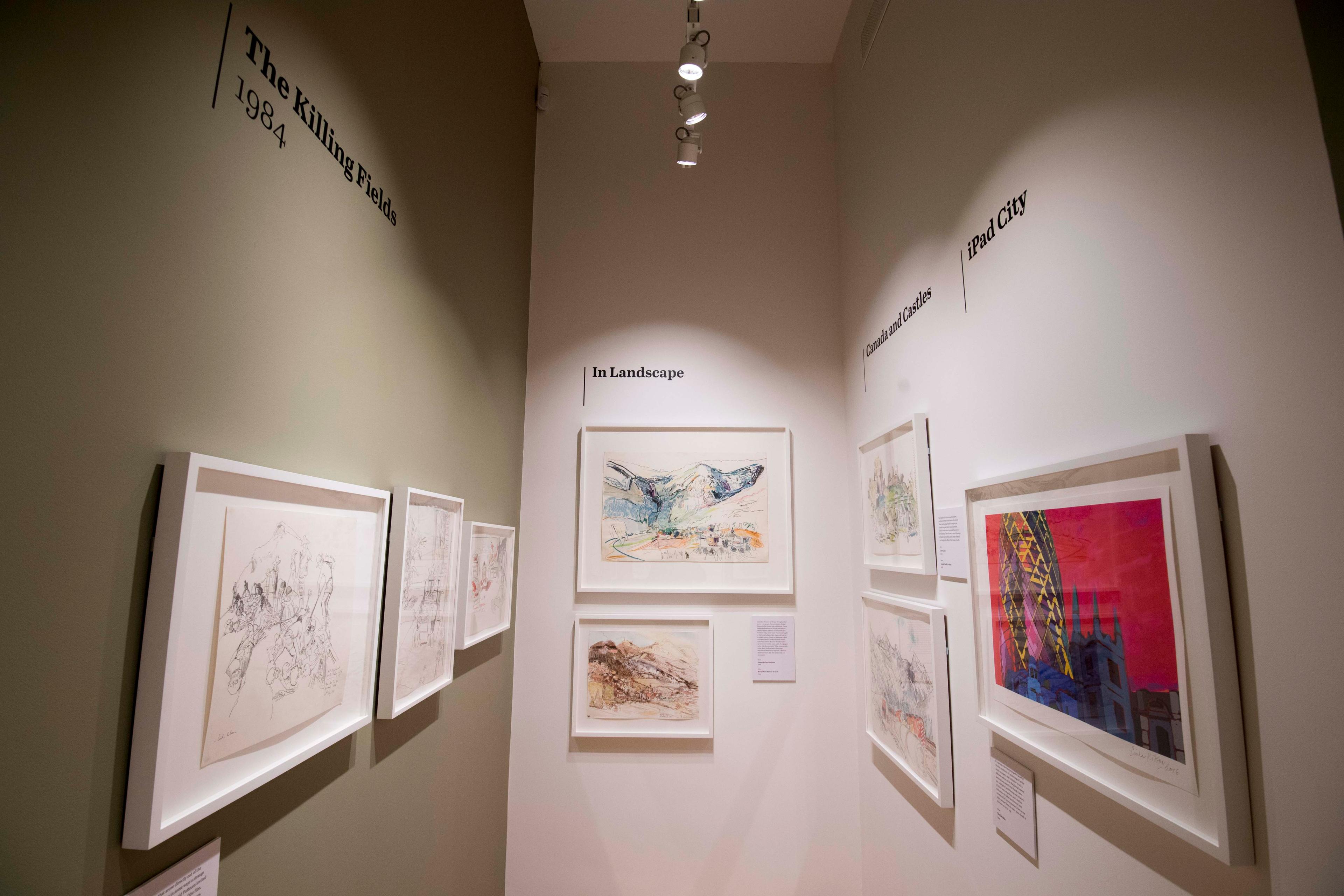 Framed illustrations and text displayed on a wall in an exhibition space.