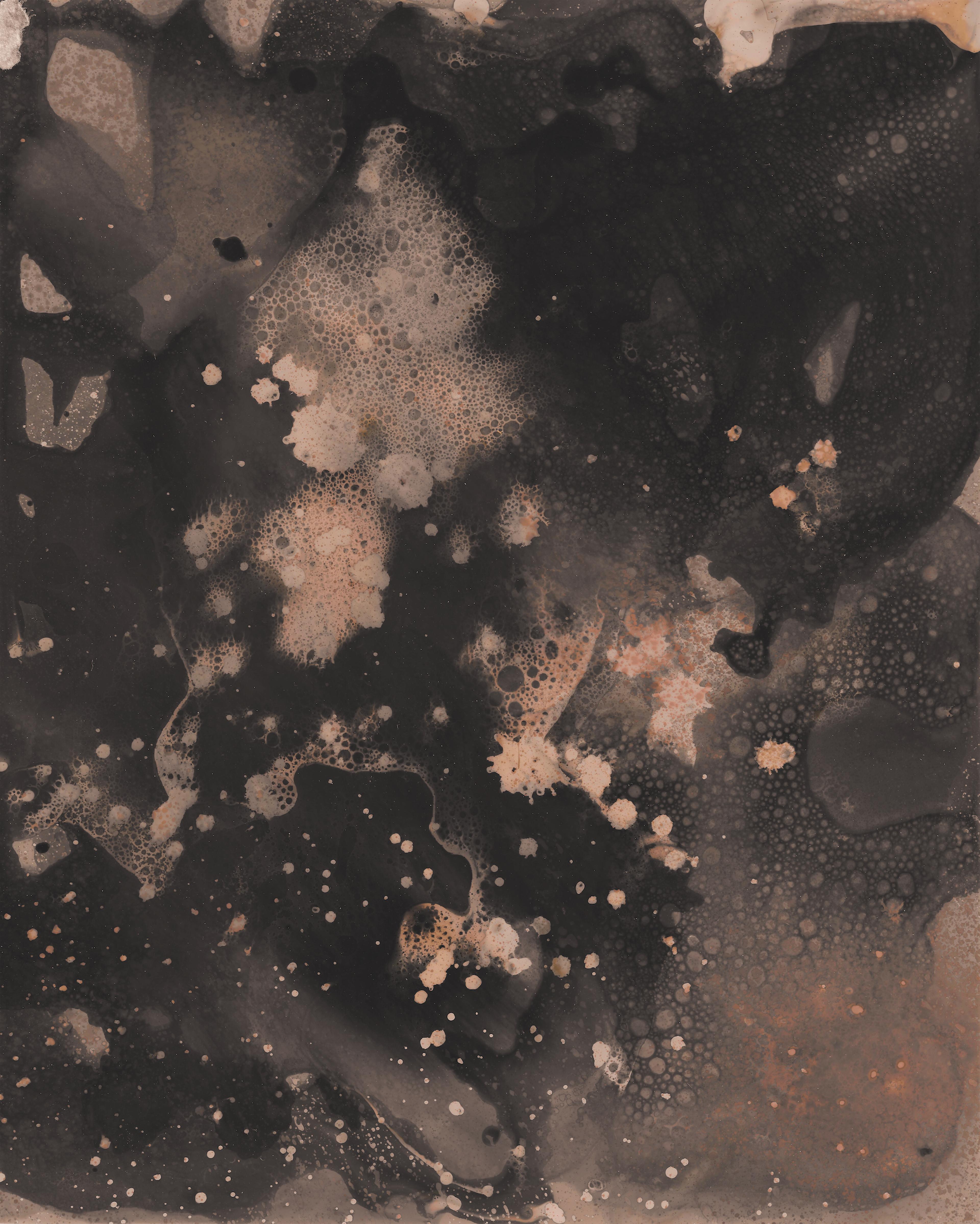 Abstract print with dark and light contrasting elements made by bubbling liquids and drips