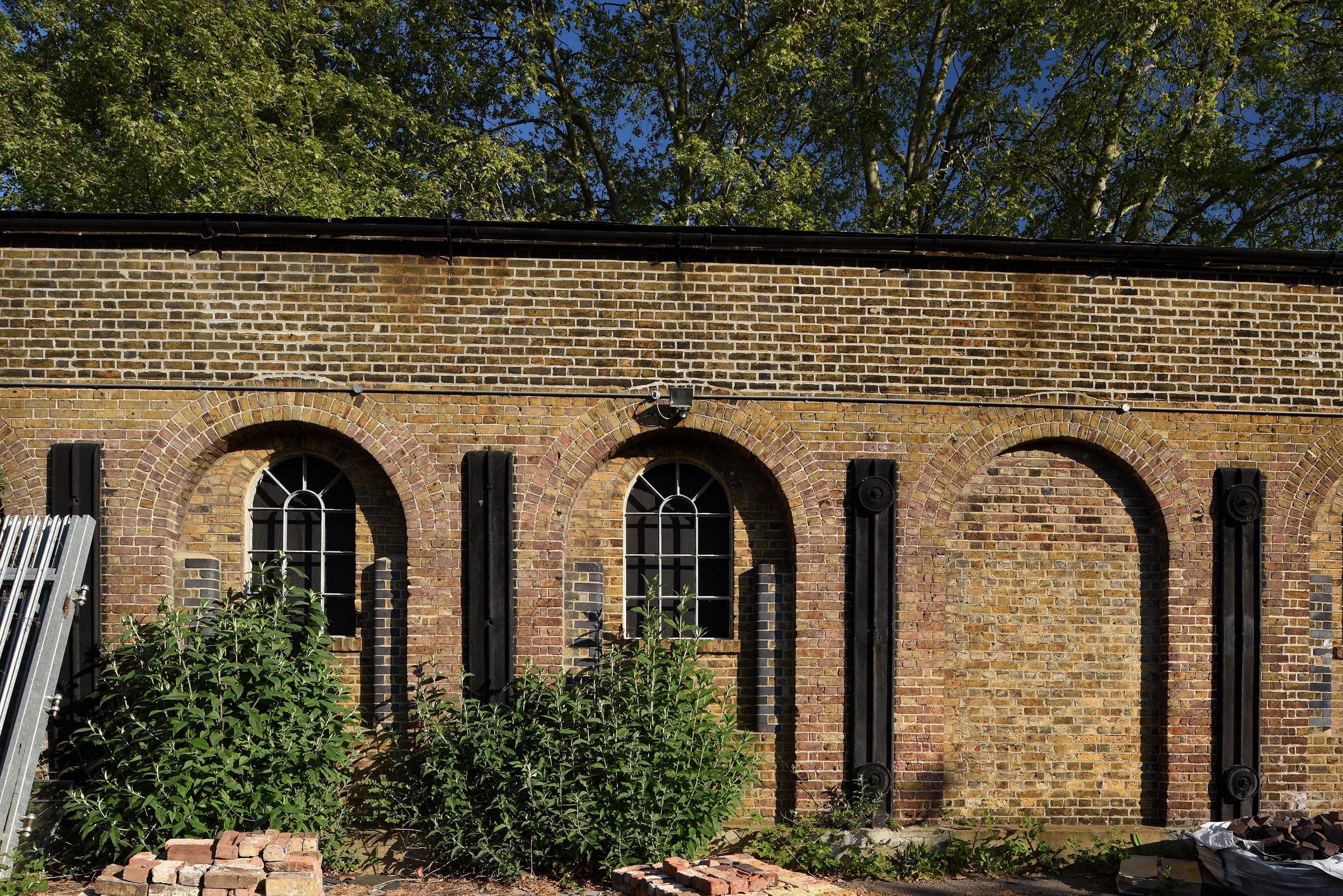 exterior of industrial brick building with rubble in front