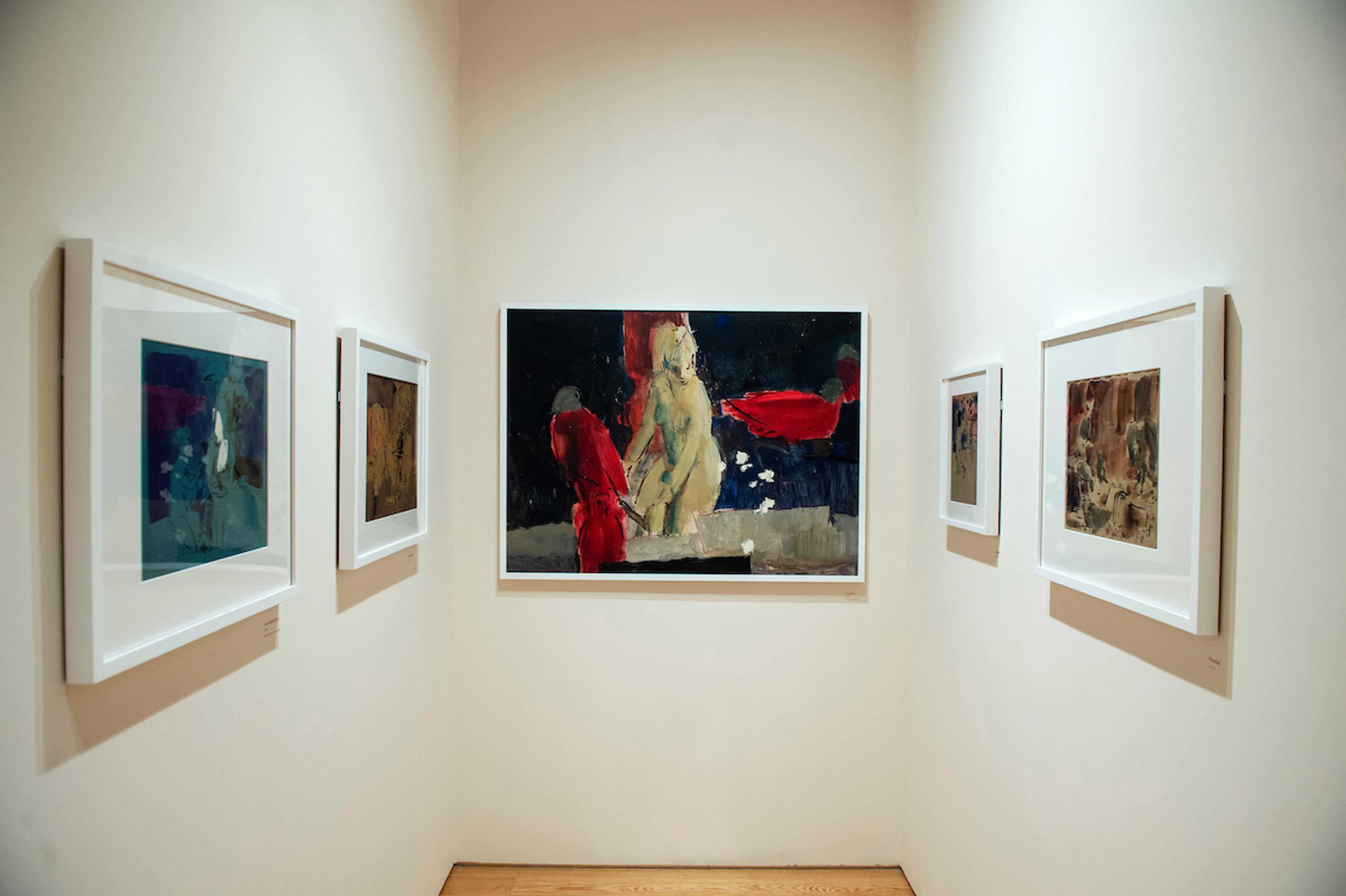 Framed illustrations displayed on gallery walls.