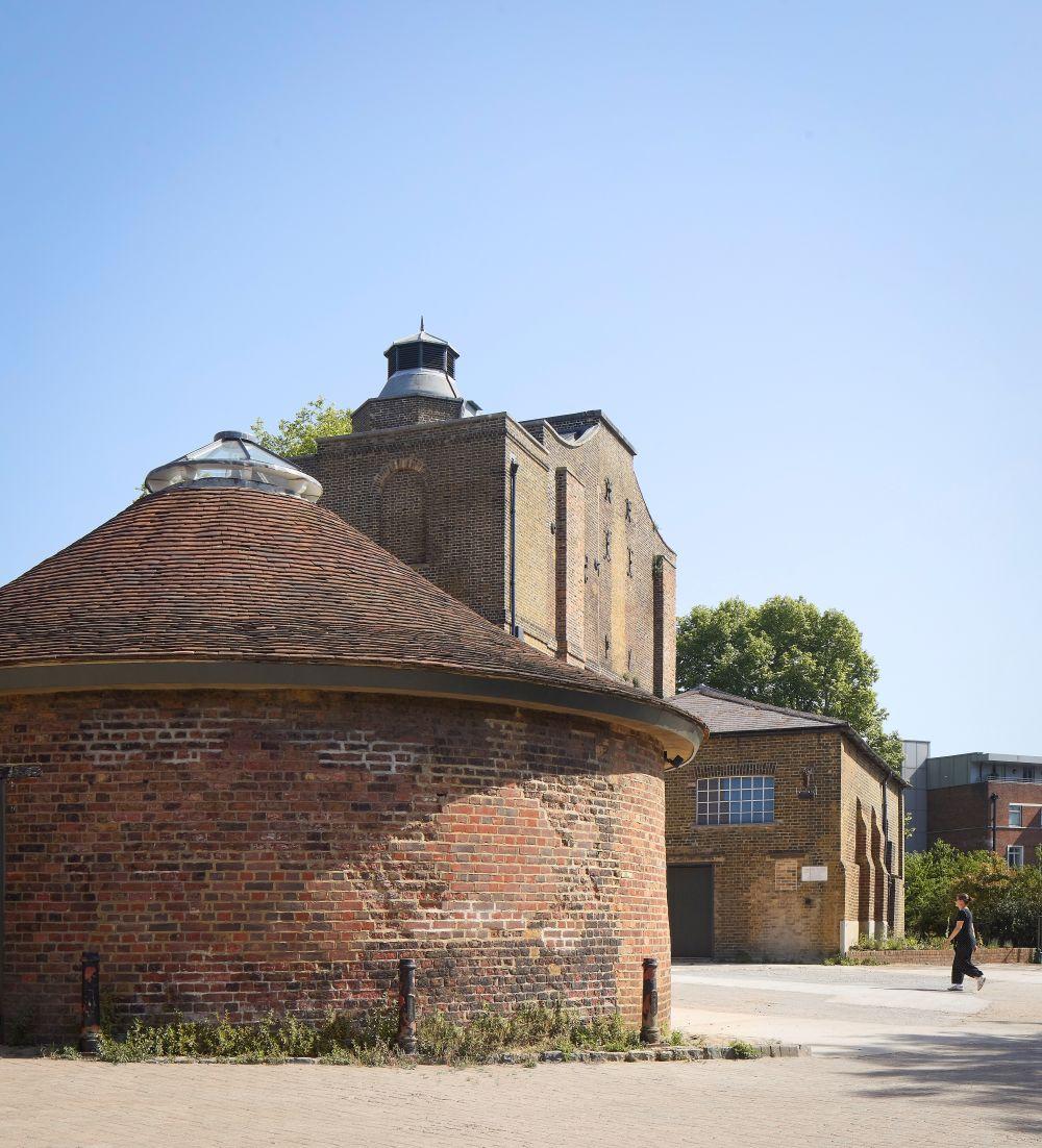 Photo of a three story building with a round one in front