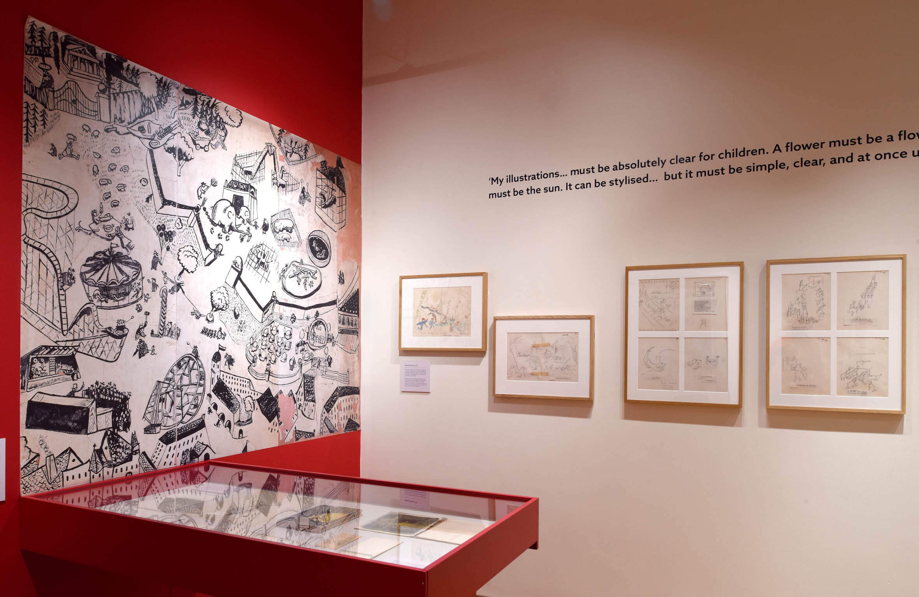 Photograph of a display case and framed artworks at the exhibition