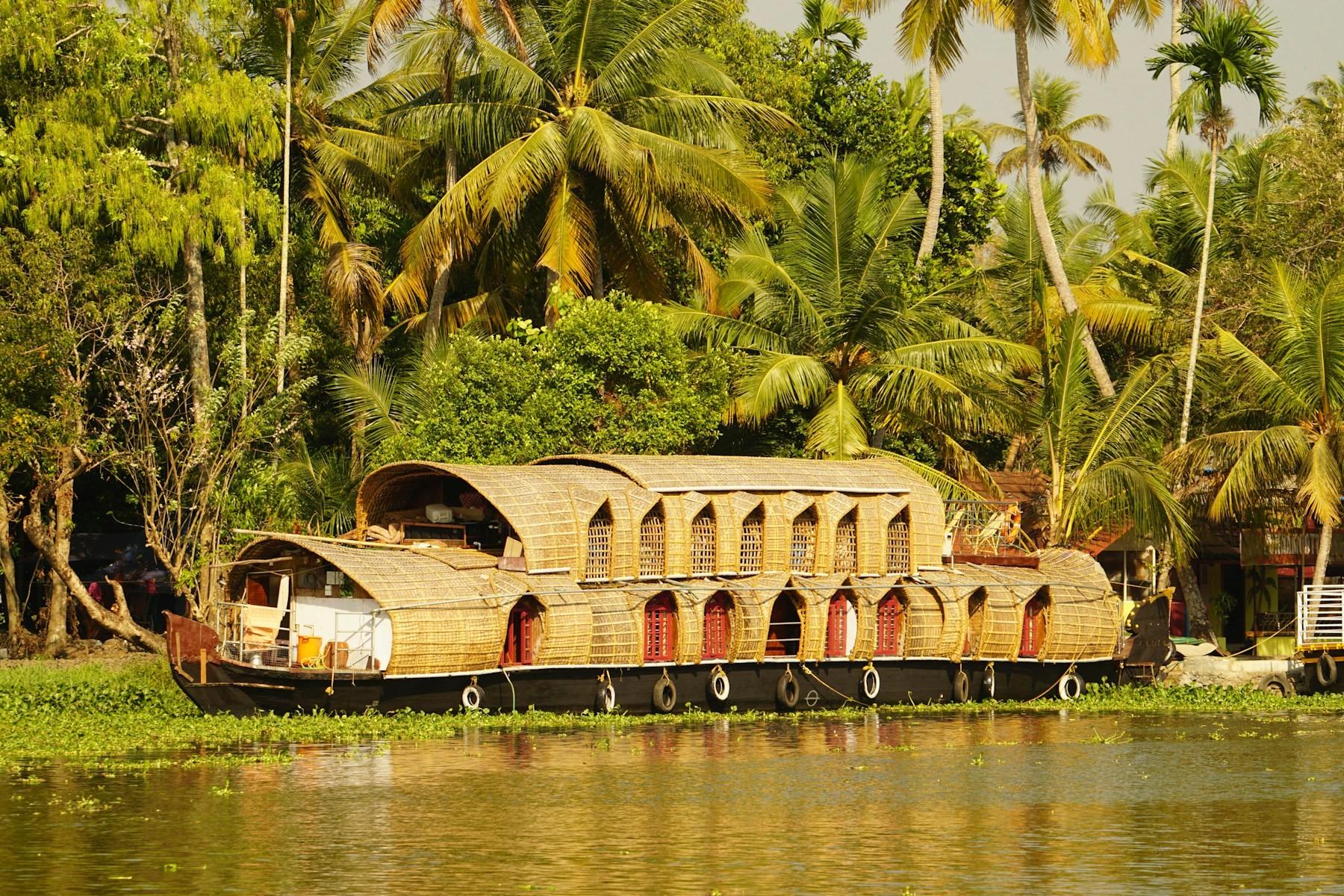 A traditional Kerala houseboat moored on the palm-lined backwaters of Alleppey