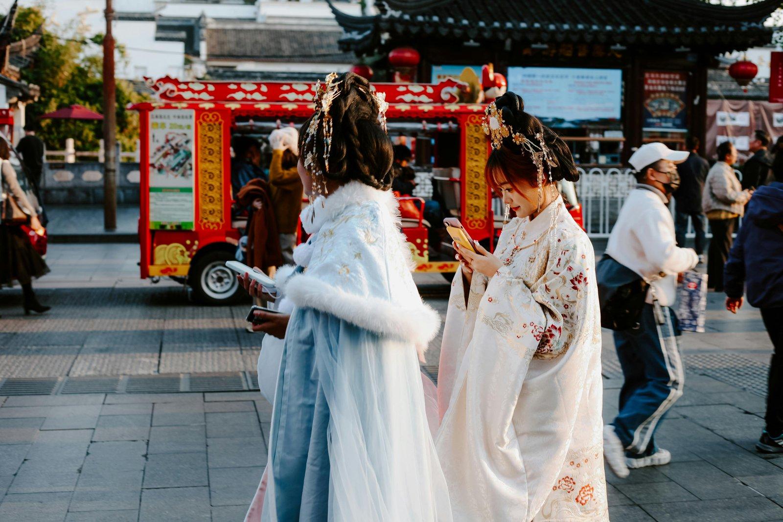 People in traditional attire on a vibrant street in Nanjing, capturing a moment of Chinese culture.