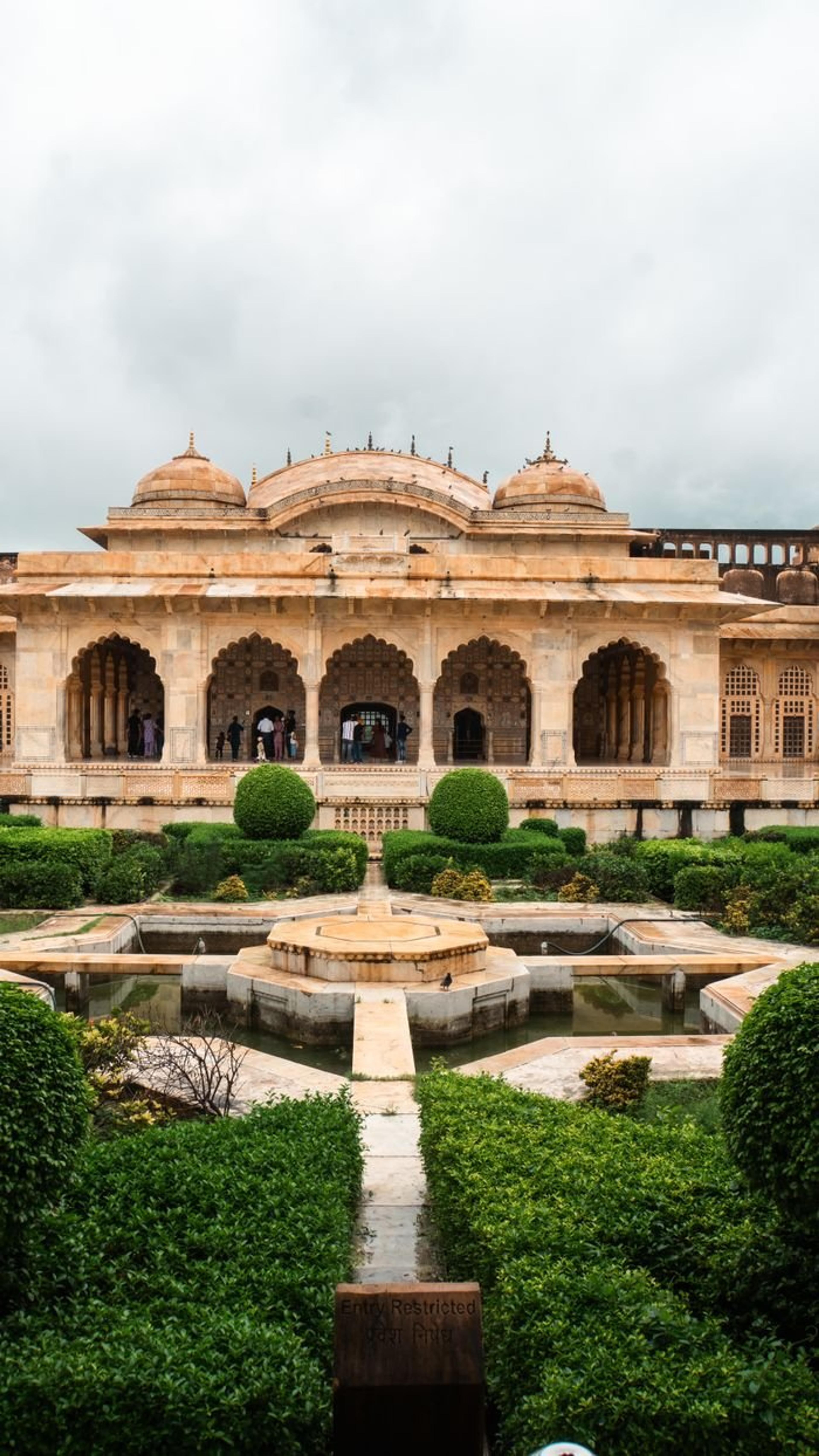 Beautiful garden view of historic architecture in Jaipur, India showcasing traditional design.
