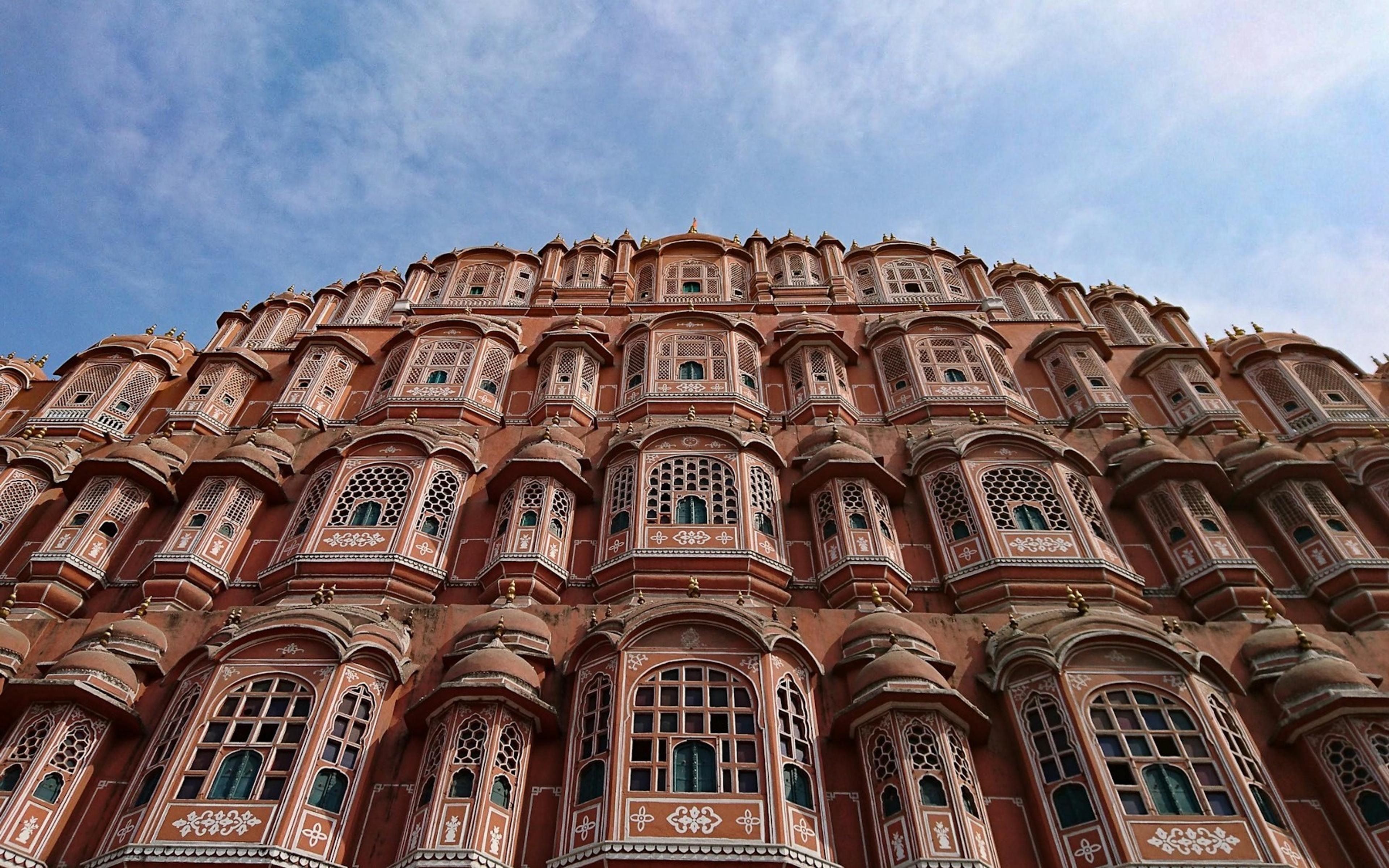 The pink sandstone facade of the Hawa Mahal, the Palace of Winds, in Jaipur