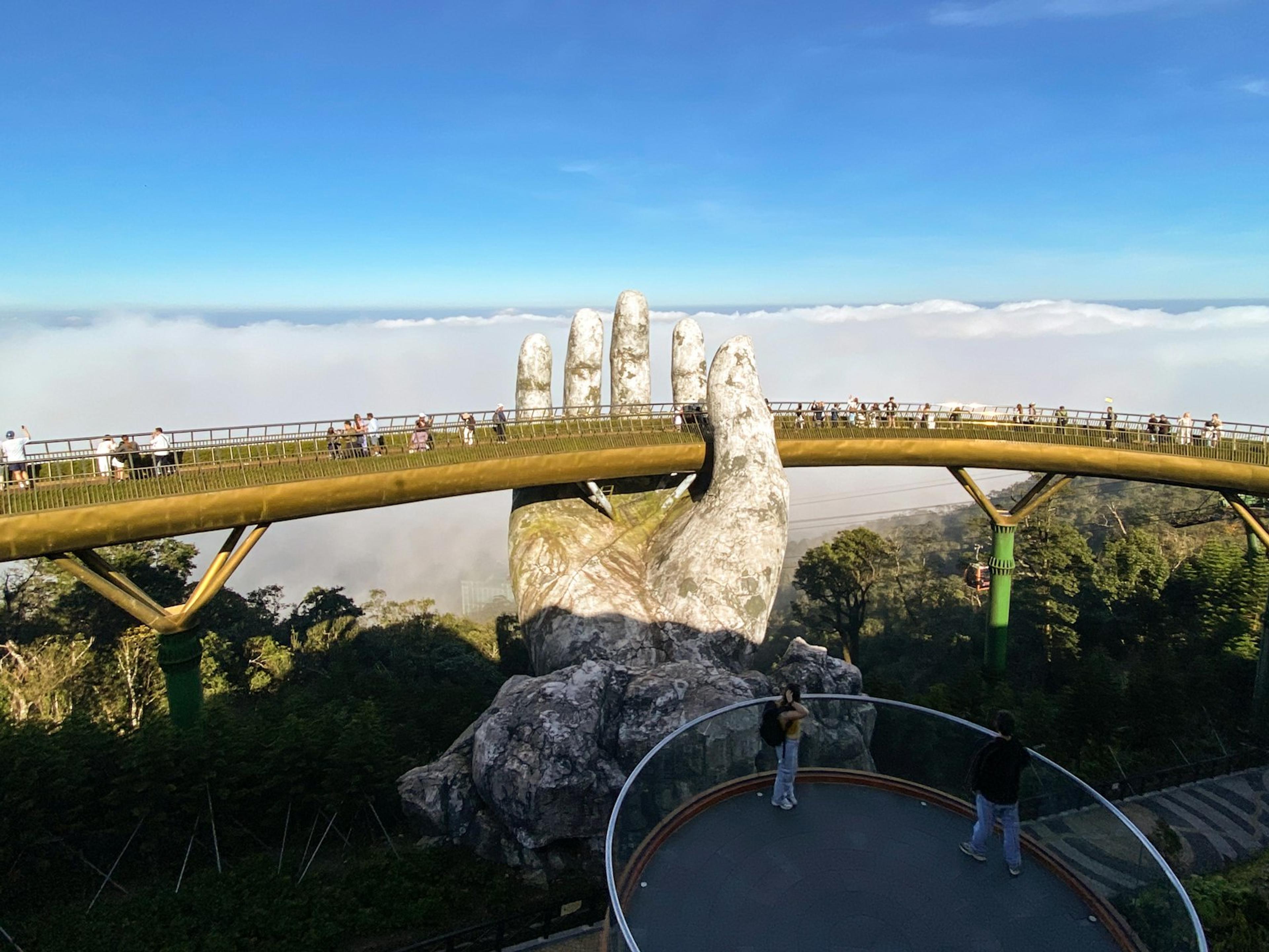 The Golden Bridge at Ba Na Hills, Da Nang, held up by two giant stone hands above the clouds