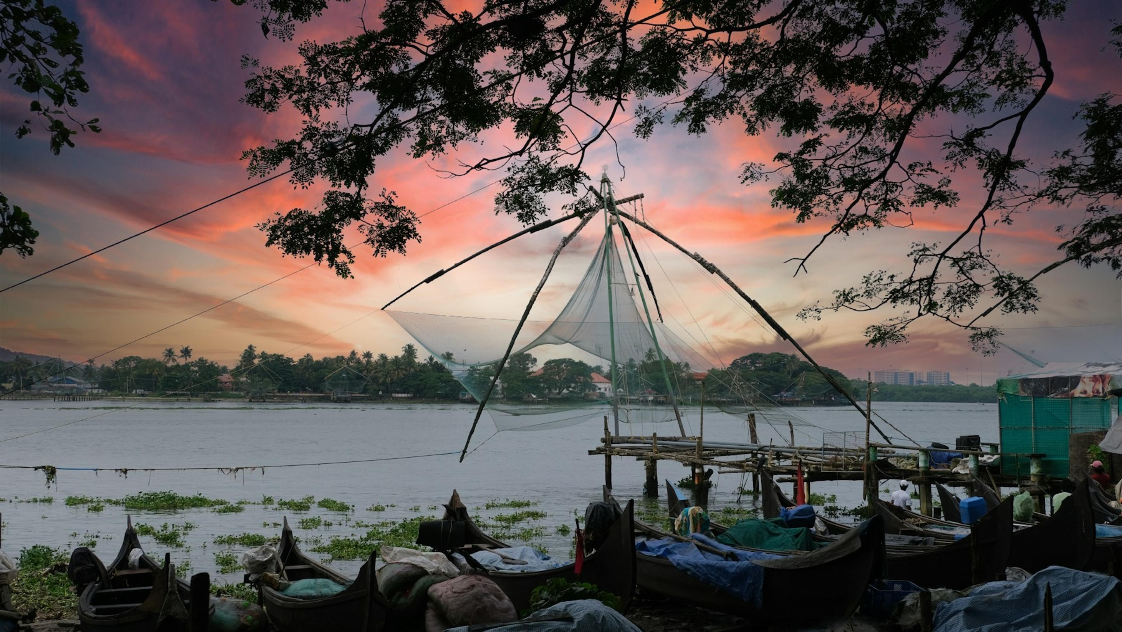 Chinese fishing nets silhouetted against the sunset at Fort Kochi