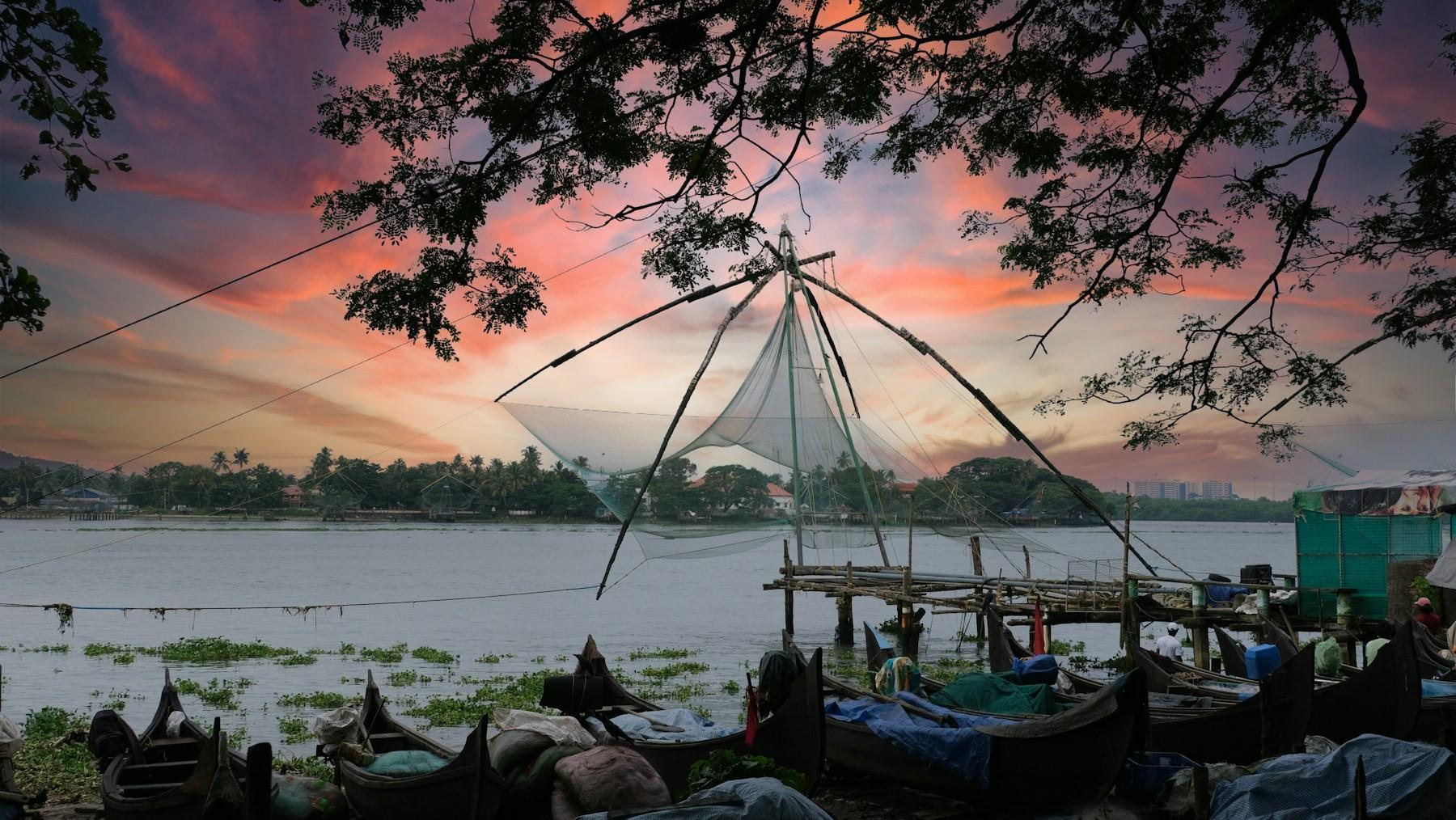 Chinese fishing nets silhouetted against the sunset at Fort Kochi
