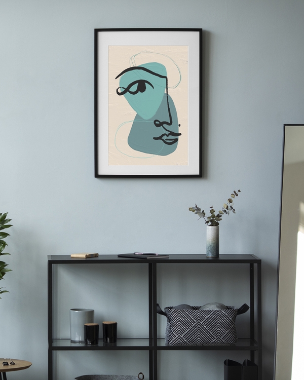 A poster of a Abstract teal face with black line on beige background