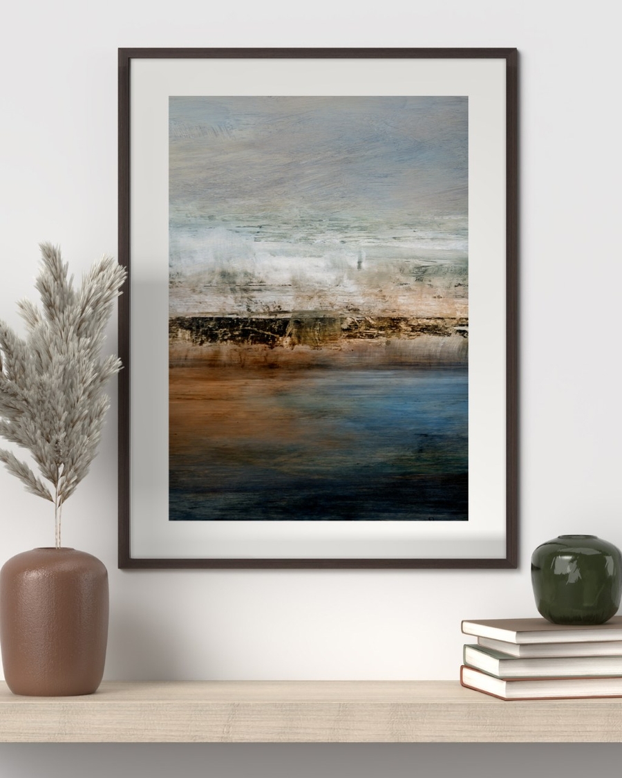 Copper Shore poster in a dark wood frame above a light wooden shelf with dried grass and books