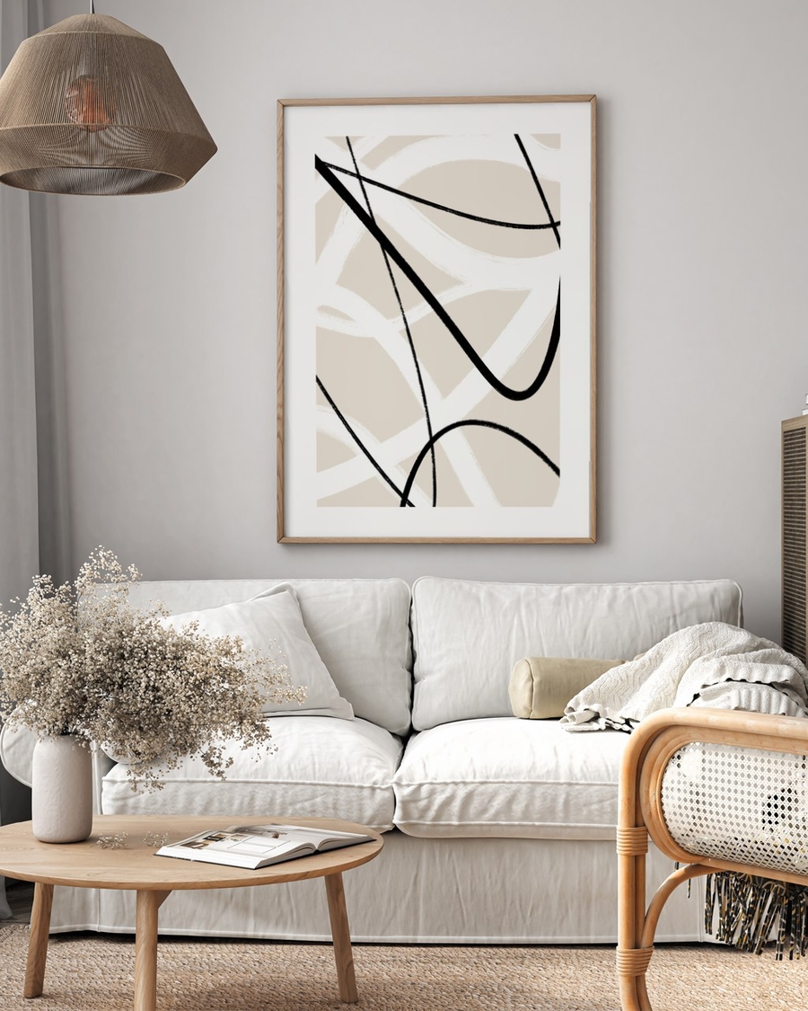 Arcs on Beige poster in a light oak frame above a white sofa in a neutral living room