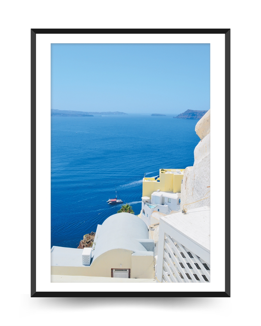 A poster of a White coastal buildings overlooking deep blue sea