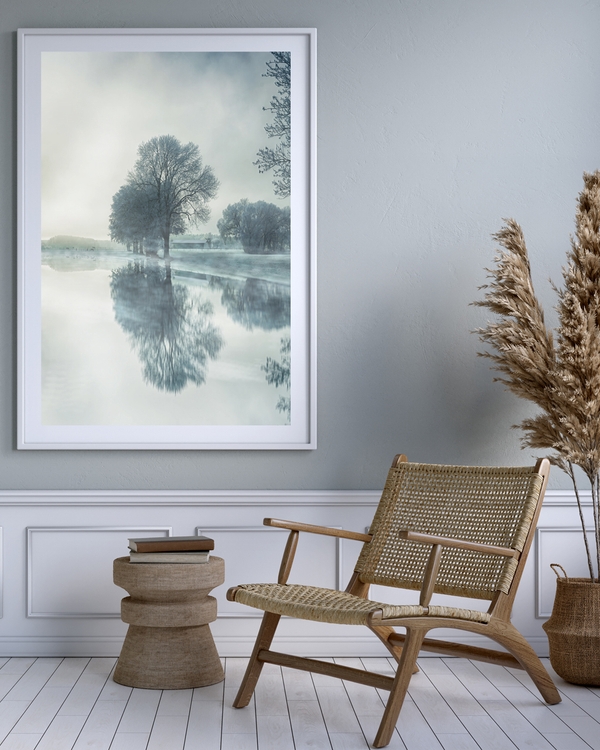 A poster of a Frosty trees reflected in calm misty winter water