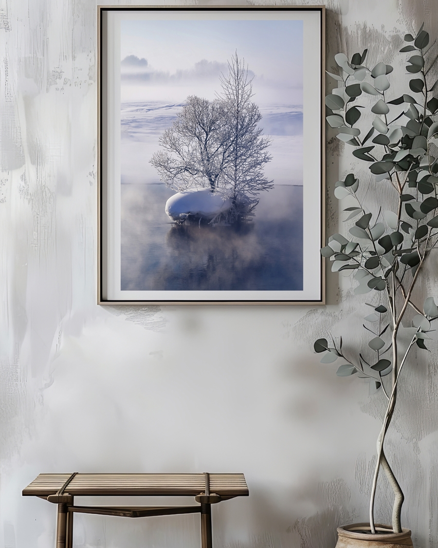 A poster of a Snow-covered tree reflected in calm winter water.