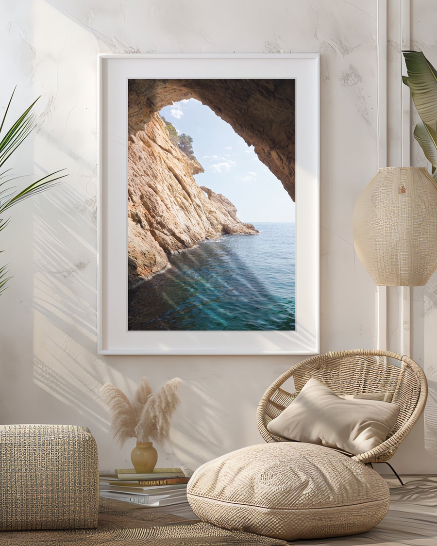 A poster of a Rocky coastal cave opening toward calm blue sea