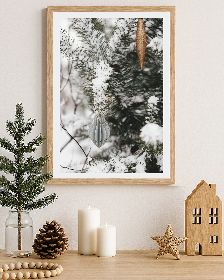 A poster of a snow-covered pine branches with elegant Christmas ornaments