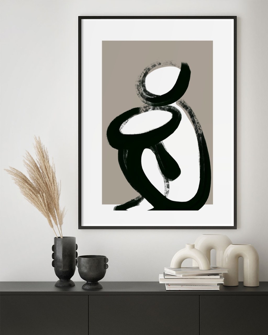 Ink Figure at Rest poster in a slim black frame above a dark sideboard with pampas grass