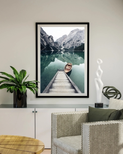 A poster of a wooden dock and boat on calm mountain lake