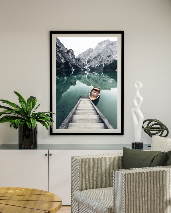 A poster of a wooden dock and boat on calm mountain lake