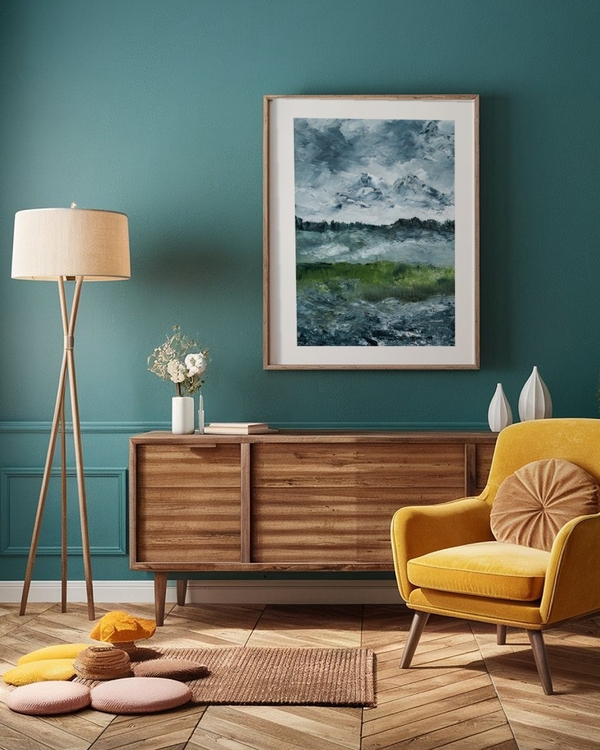 Peaks Beyond the Meadow poster in a light wood frame above a wooden sideboard on a teal wall