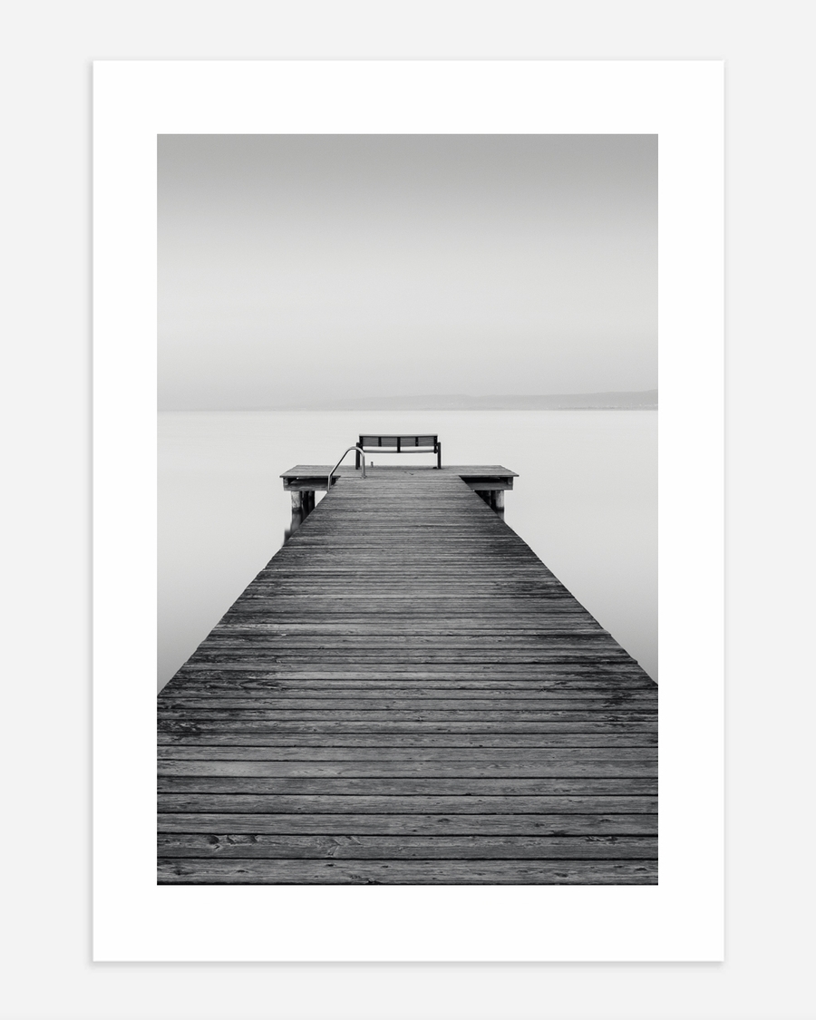 A poster of a Wooden pier leading into calm water and horizon