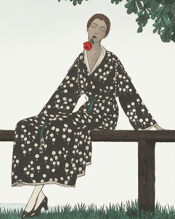 Woman in a black and white floral robe sitting on a brown bench