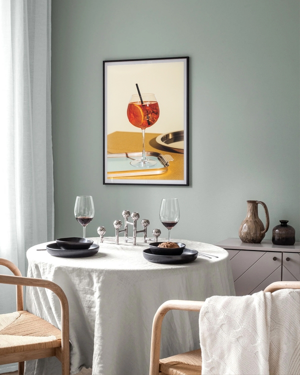 A poster of a Orange cocktail in wine glass on tray