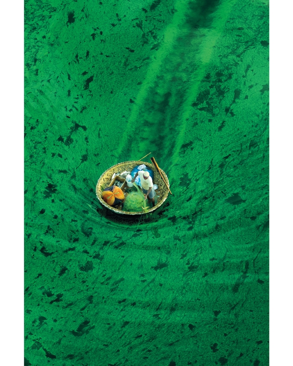 Small boat floating in clear green water