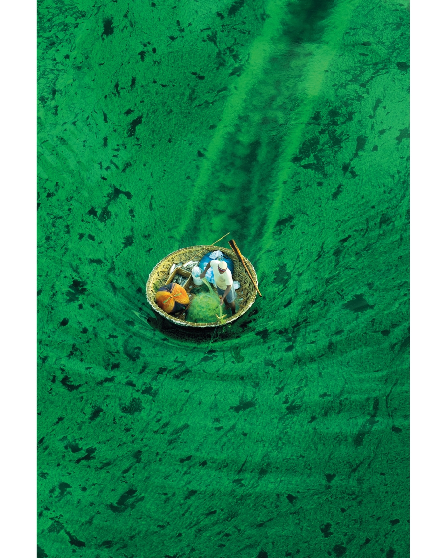 Small boat floating in clear green water