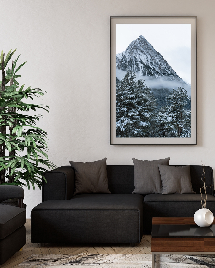 Snow-covered mountain peak above misty pine forest poster i livingroom