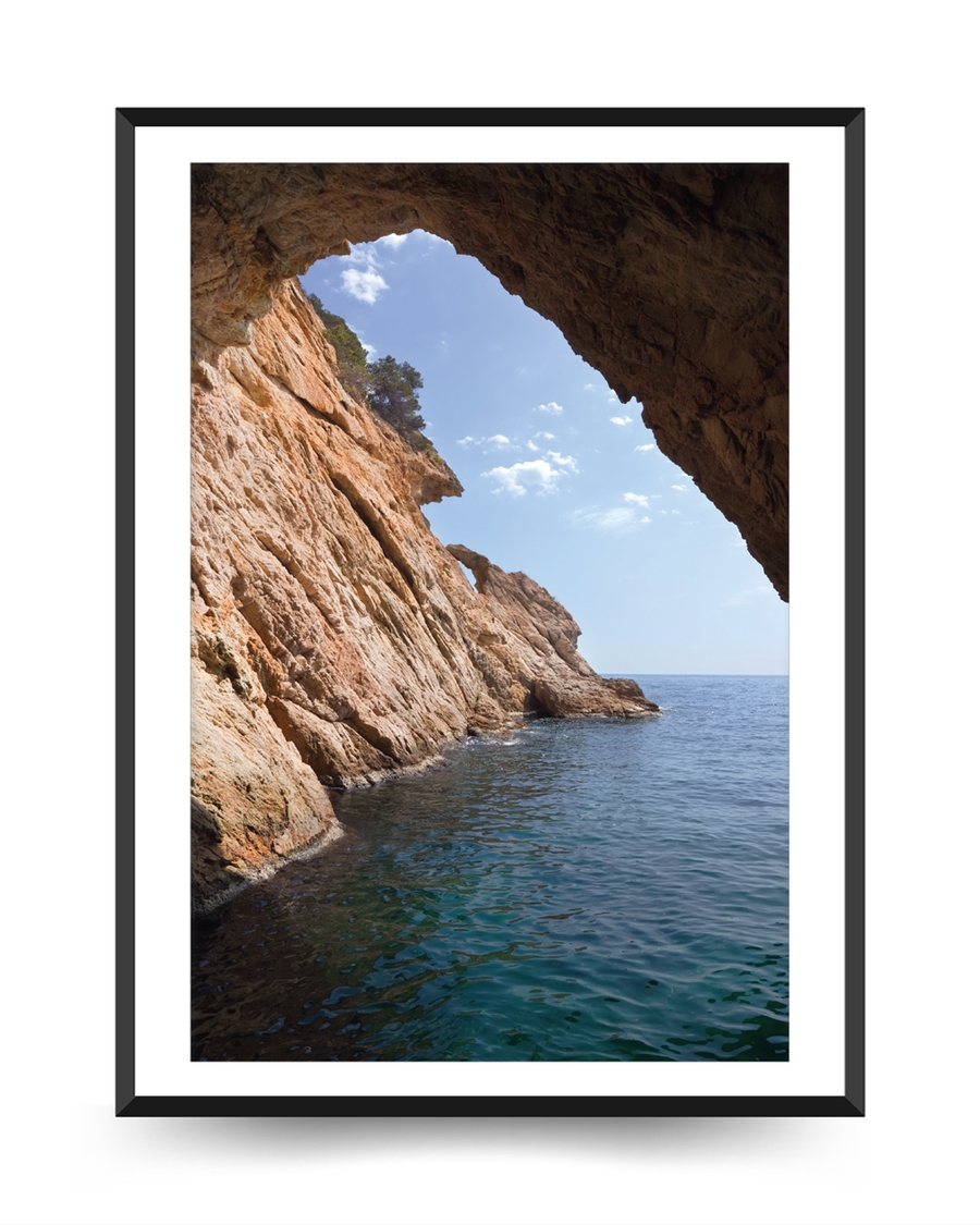 A poster of a Rocky coastal cave opening toward calm blue sea