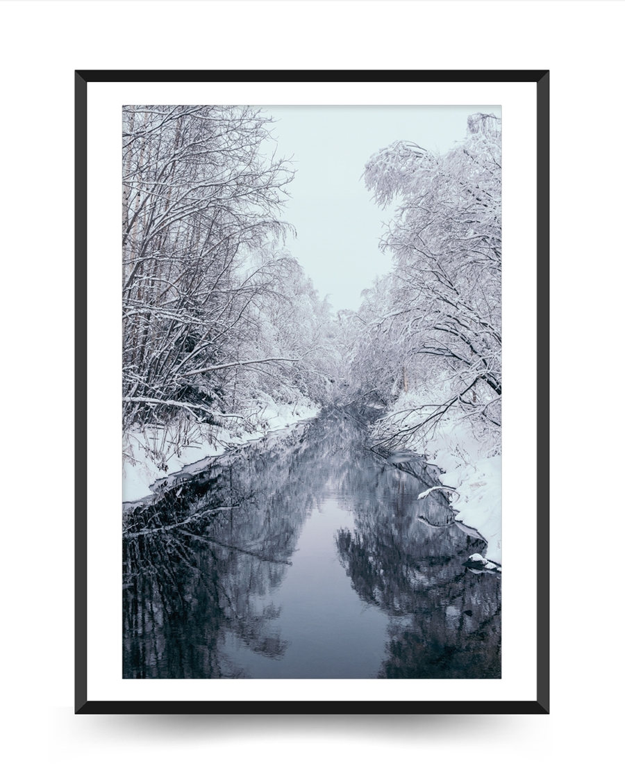 A poster of a Snow covered trees reflected along quiet winter stream