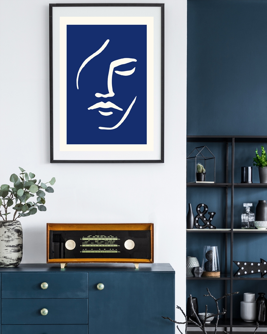 A poster of a light beige minimalist face outline on deep blue background.