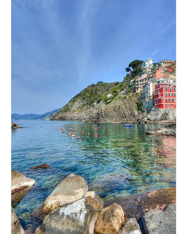 Colorful houses on rocky coast with clear water