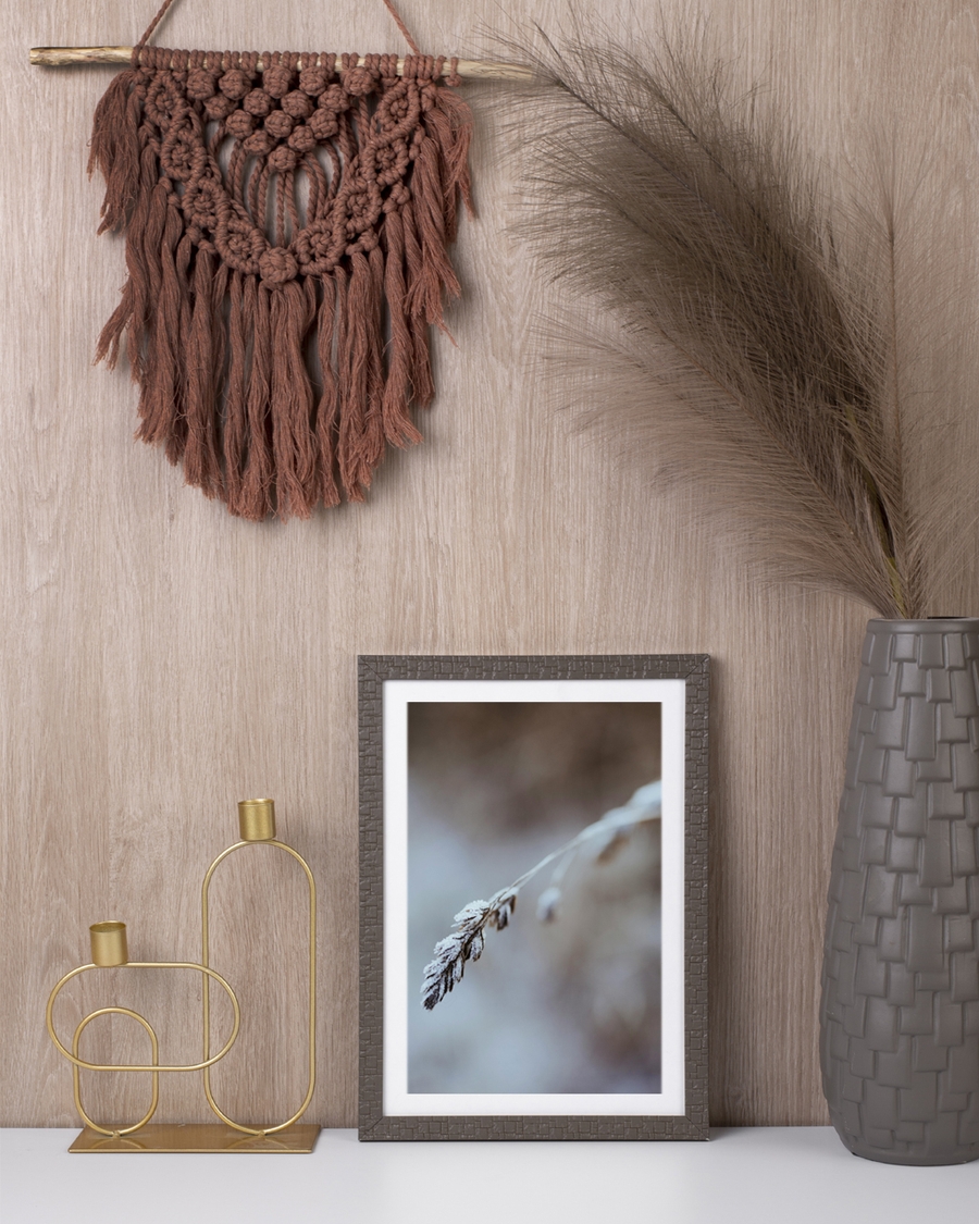 A poster of a close-up of frosted grass stem in soft winter tones