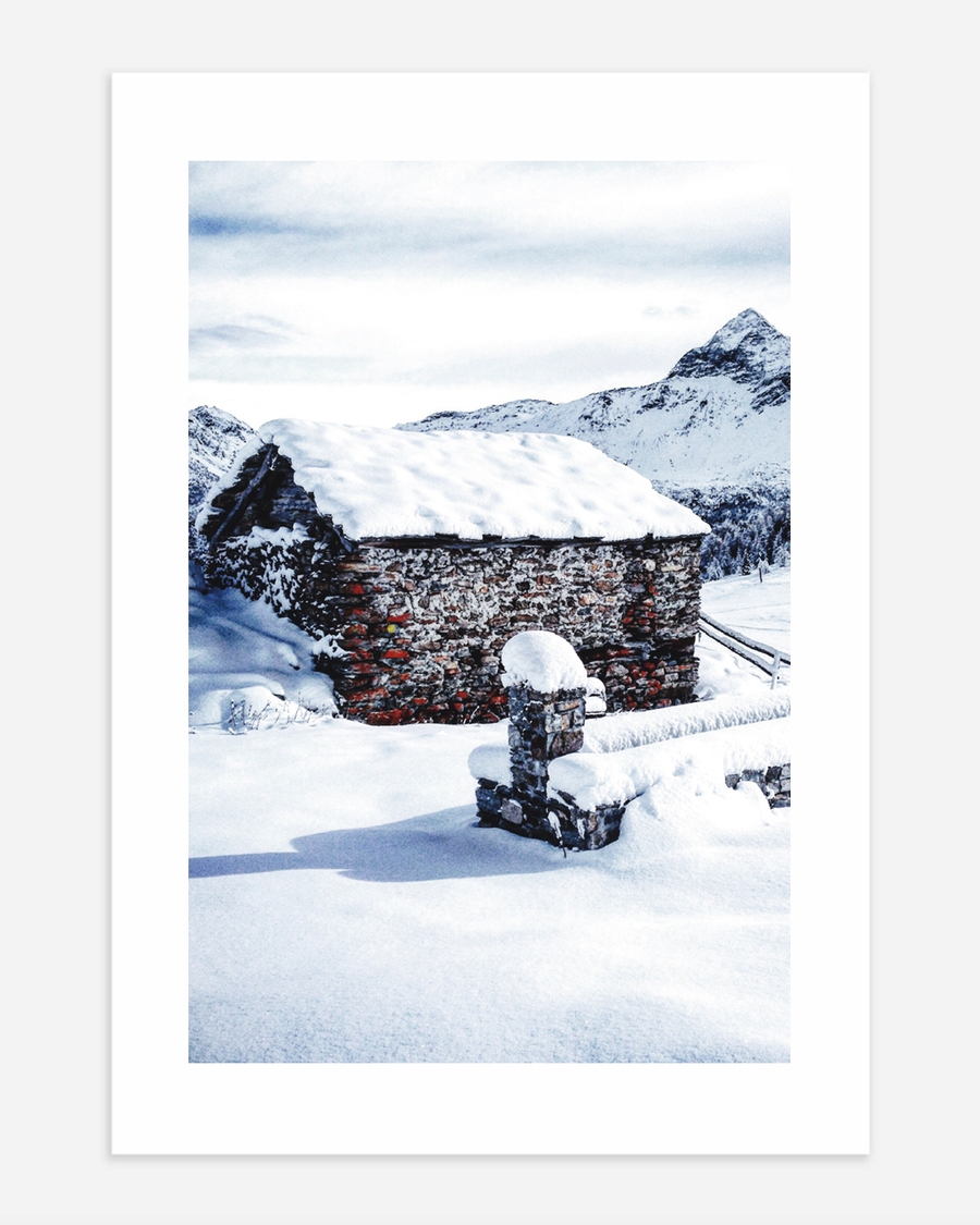 A poster of a Stone cabin surrounded by snow and mountains